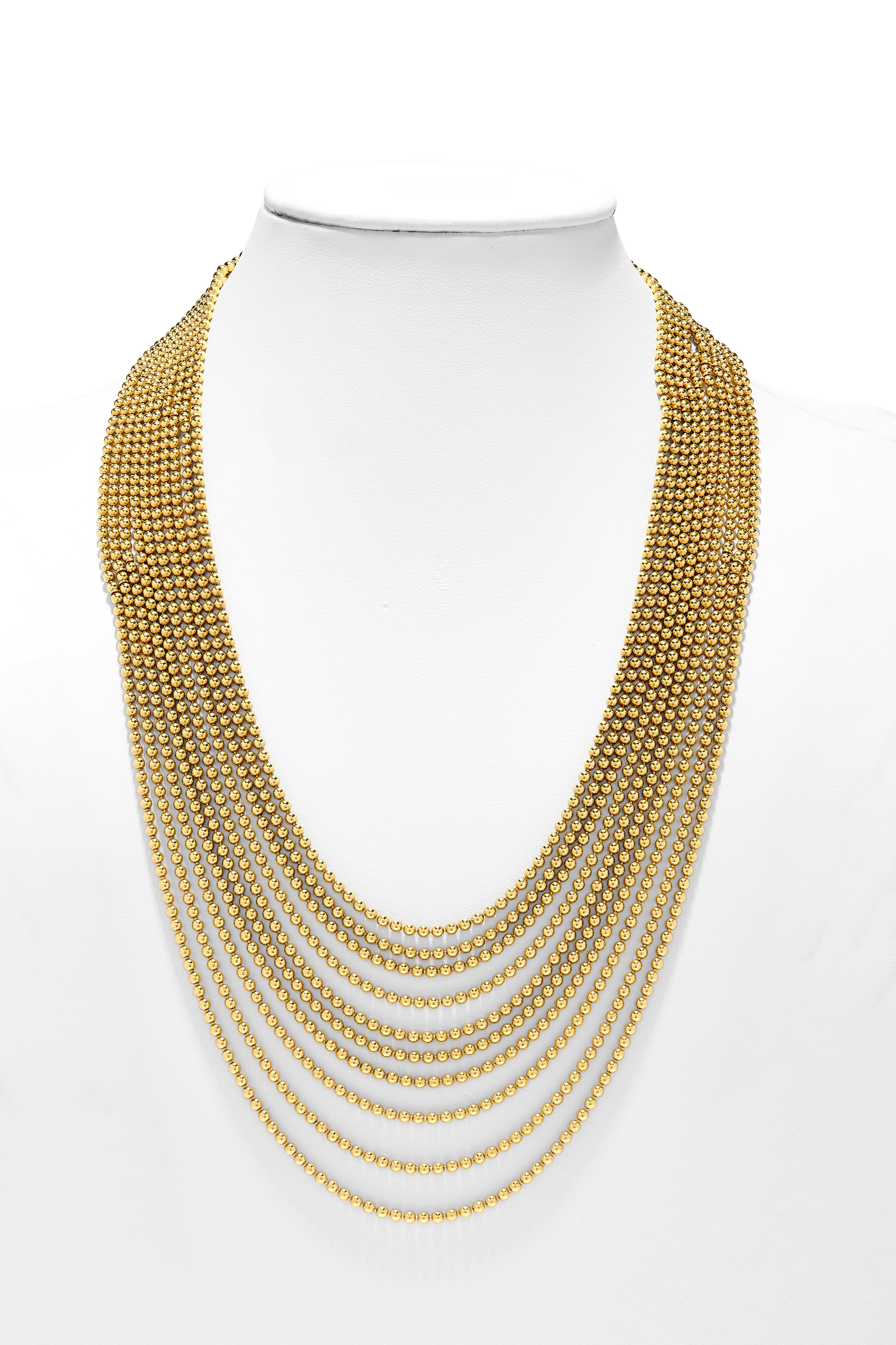 This exquisite Cartier Demiparure from the Draperie Collection is a mesmerizing display of craftsmanship and elegance. Crafted in luminous gold, the set features a necklace comprising ten opulent rows of delicate gold spheres, exuding a timeless