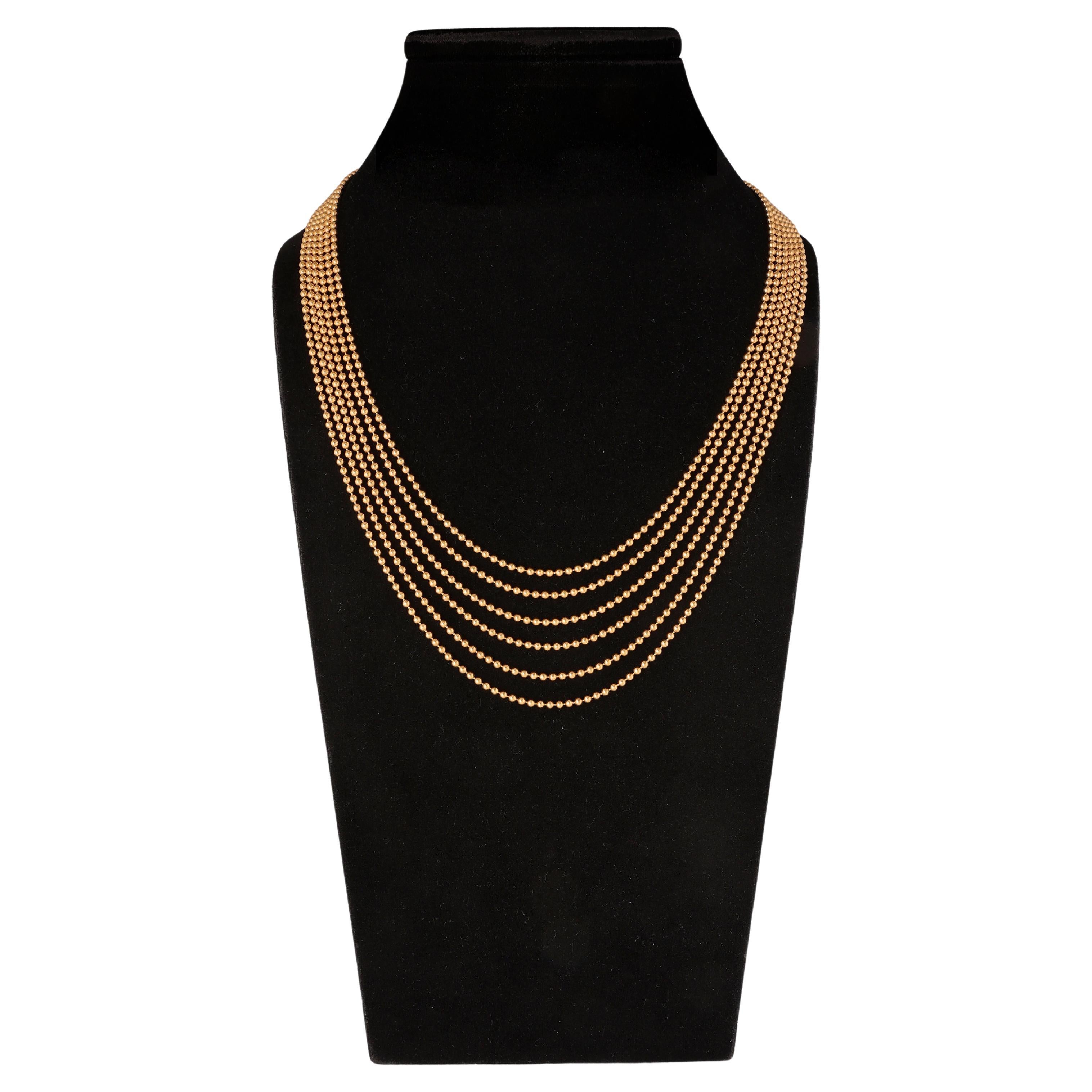 This beautiful waterfall necklace by Cartier from their 'Draperie De Décolleté' collection dresses the neckline in a bold and elegant way. The piece is masterfully crafted from high polish 18 carat yellow gold and showcases 6 strands of slender ball