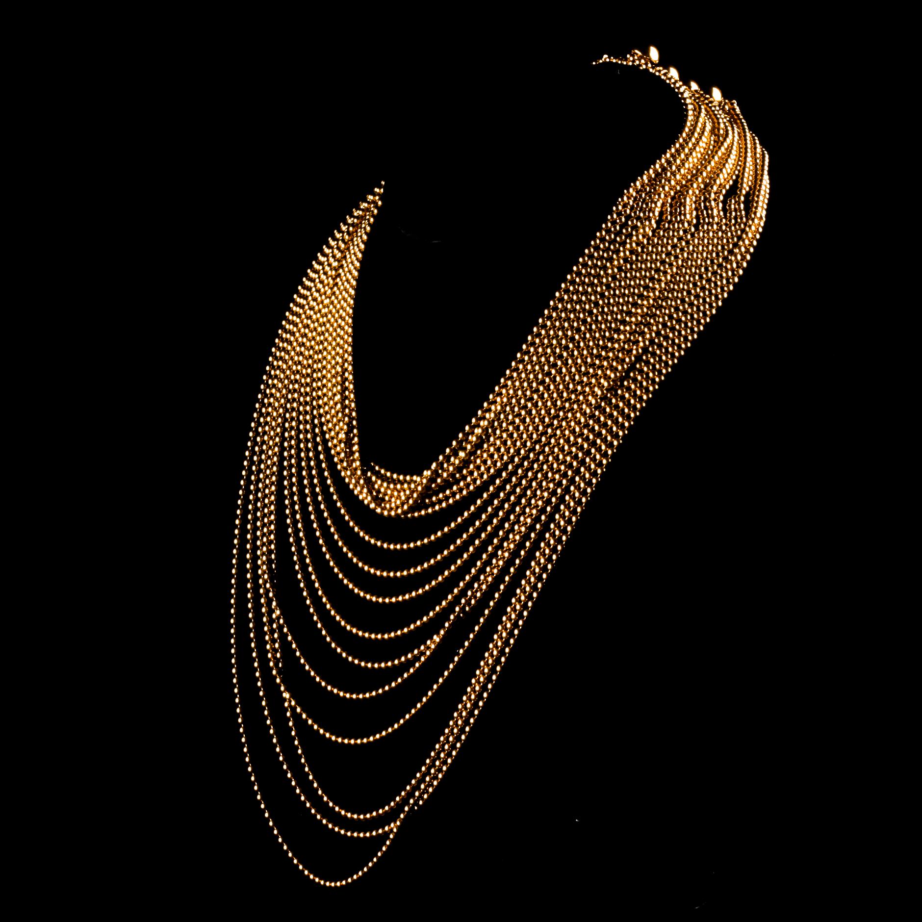 Gorgeous Vintage Gold Necklace from Cartier
Issued in the late 1990s
Features 18 rows of lengthening 18k Yellow Gold bead chains to create a draping bib effect
Approximately 14