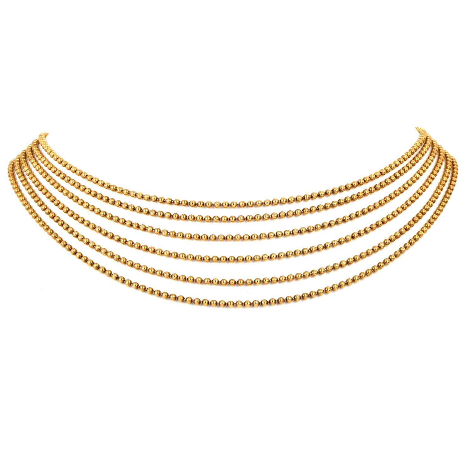 
This sexy draperies de Décolleté piece is crafted in solid 18K yellow gold beads, gradually presented in 6 strands of 2 mm width each. This overlay chain design is very trendy in the current fashion industry.

Secured by three button insert