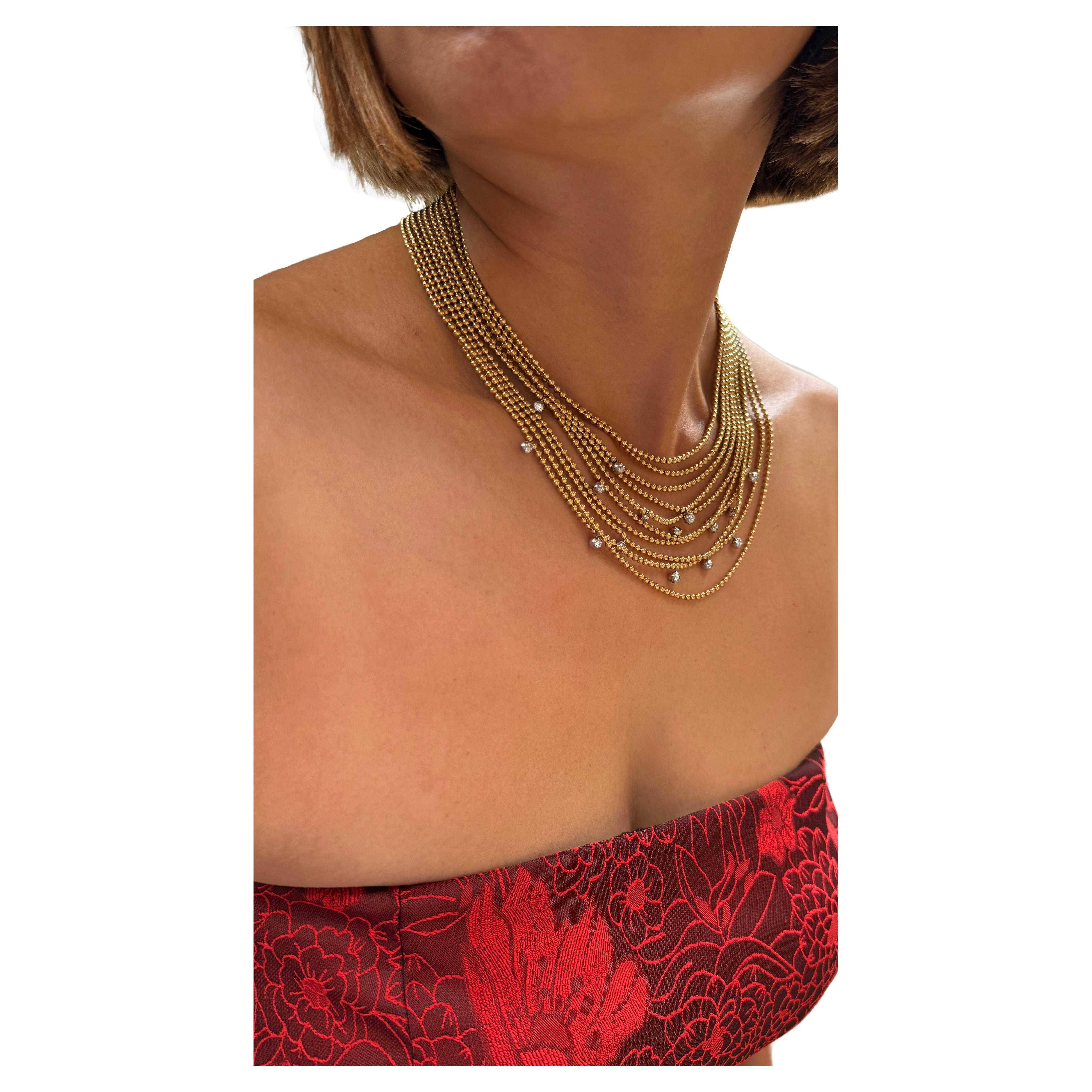 Cartier NECKLACE from the DRAPERIE collection consisting of 10 rows of yellow gold chain-link balls with randomly 15 brilliant cut diamonds in a white white gold bezel setting.  button hole closure length of the first row of golden balls .
Gram