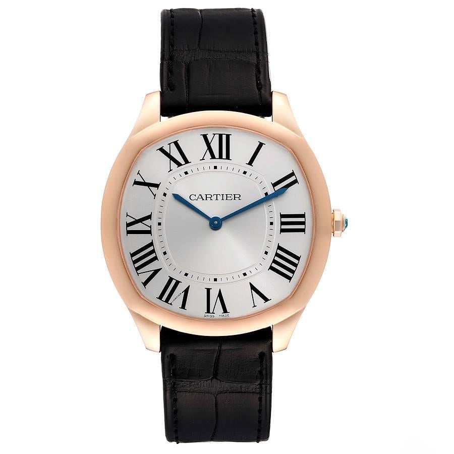 Cartier Drive de Cartier Rose Gold Silver Dial Mens Watch WGNM0006. Manual winding movement. Cousion shape 18k rose gold case 38.0 x 39.0 mm in diameter. Crown cover with faceted blue spinel. 18k rose gold concave bezel. Scratch resistant sapphire