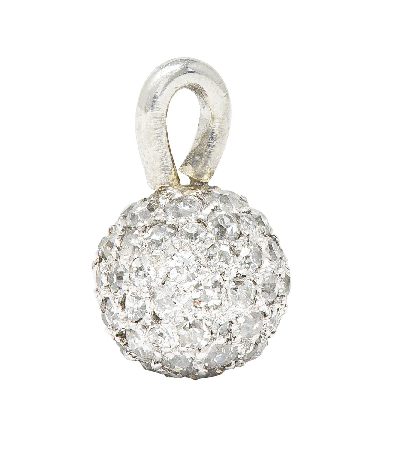 Petite charm is designed as a platinum ball. Pavé set fully around with old single and single cut diamonds. Weighing in total approximately 1.00 carat. Quality consistent with age and cut. Tested as platinum. Circa: 1910. Measures: 5/16 x 1/2 inch.