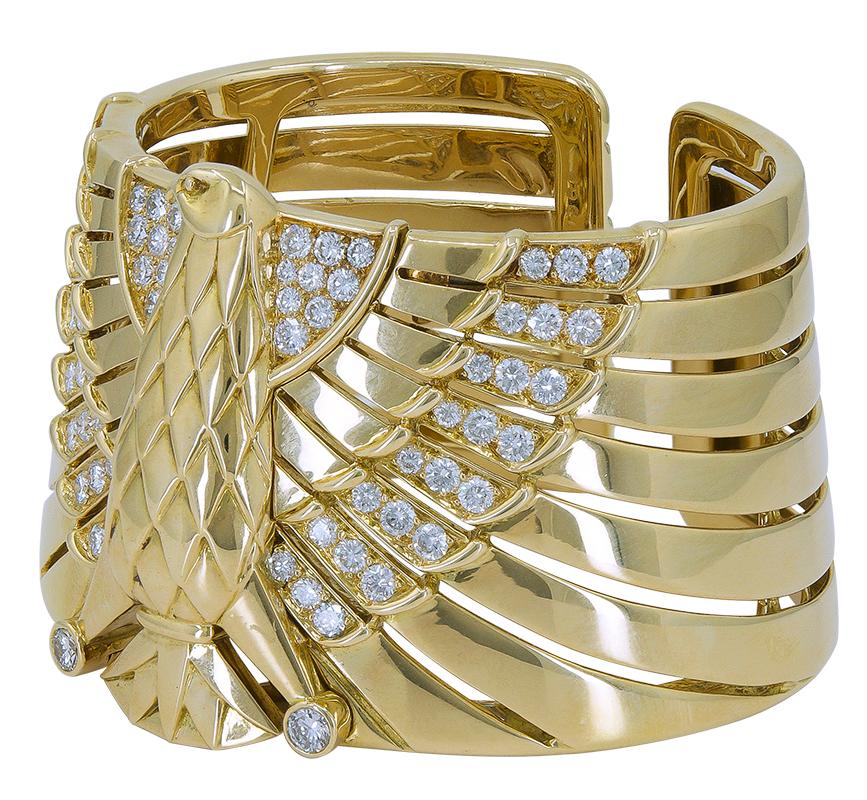 CARTIER Egyptian Revival Horus Falcon Diamond Bracelet in 18k Yellow Gold.

Diamond weight approx. 4.30 carats, F/G color, VS clarity. Overall weight of bracelet is approx. 138.20 grams. Width of bracelet approx. 1.50″ to 1.75″ (slight taper) with