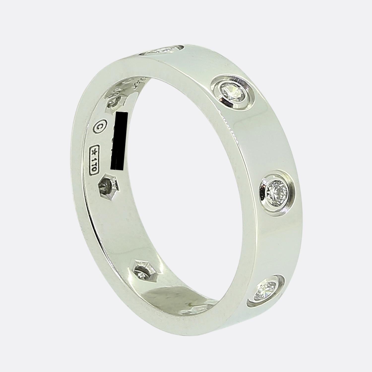 Here we have an 18ct white gold ring world the renowned luxury jewellery house of Cartier. This ring forms part of their LOVE collection with this being the slimmer/thin model featuring eight round brilliant cut diamonds around the entire