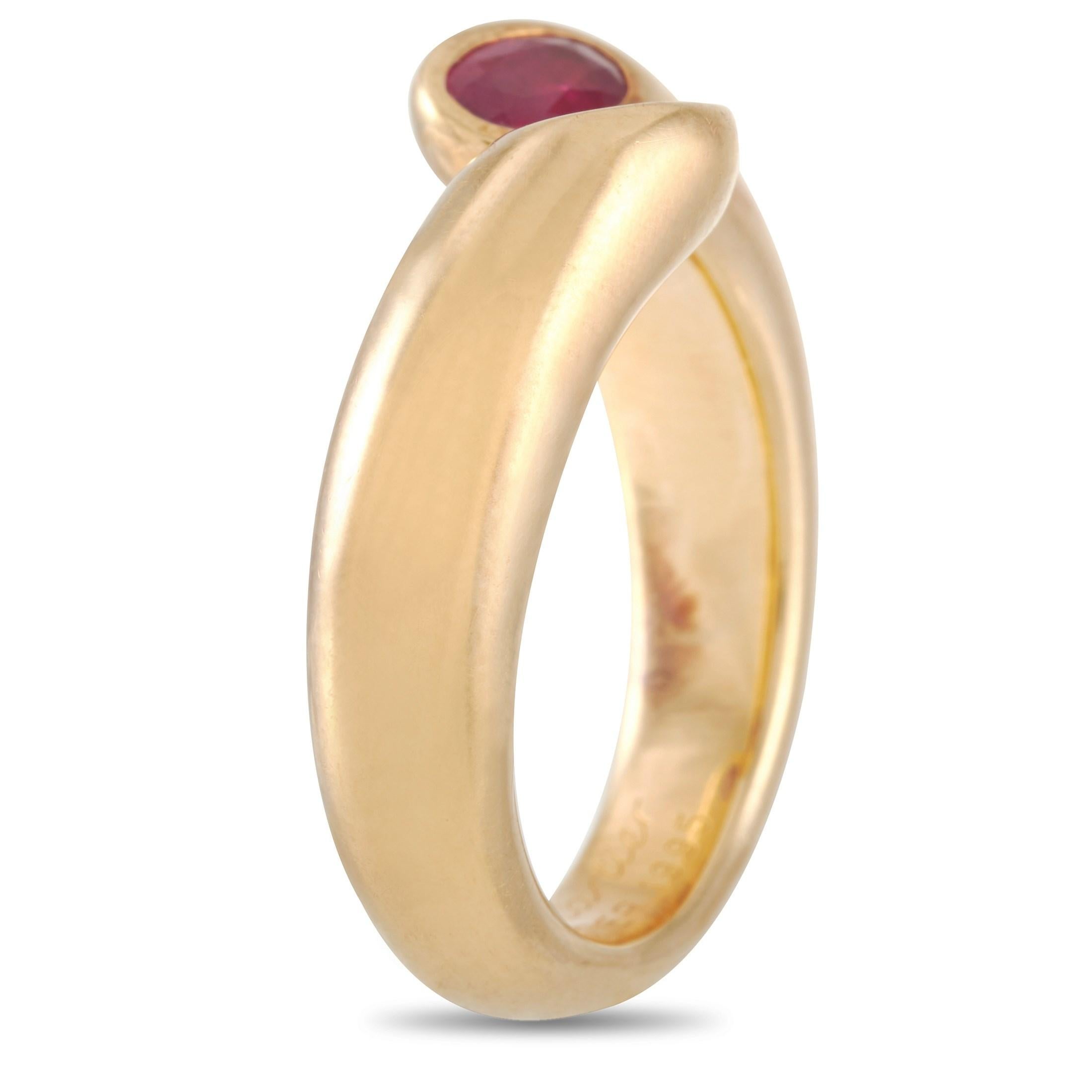 The Cartier Ellipse Deux Tetes Croisees 18K Yellow Gold Ruby Bypass Ring looks extremely chic with its contoured open bypass shank. Bringing color and an extra touch of elegance are two oval-cut ruby gemstones positioned at the rounded tips of the