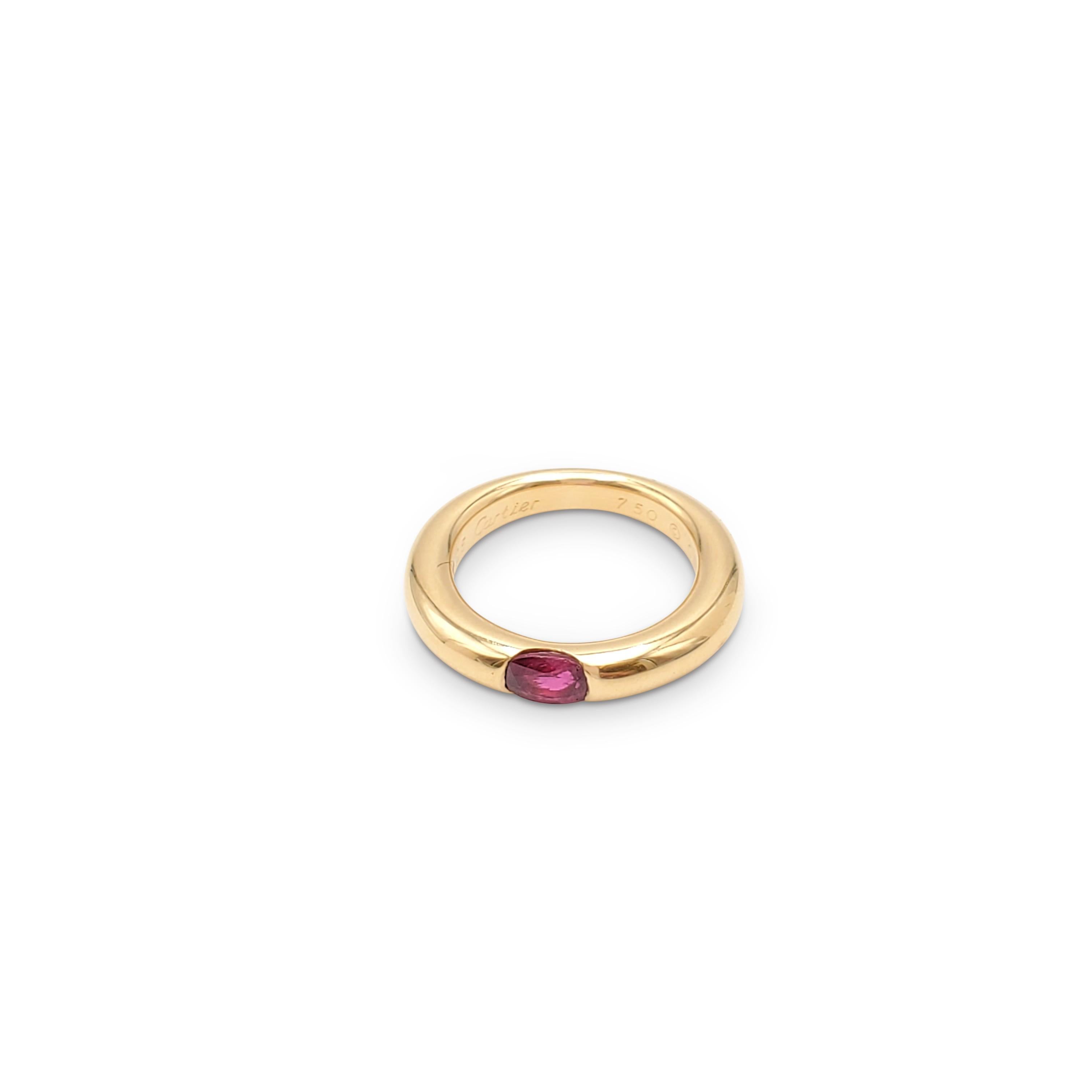 Authentic Cartier 'Ellipse' ring crafted in 18 karat yellow gold and set with one ruby stone weighing an estimated 0.35 carats total weight. Signed Cartier 1992, 750, 51, with serial number. The ring is presented with the original box and papers.