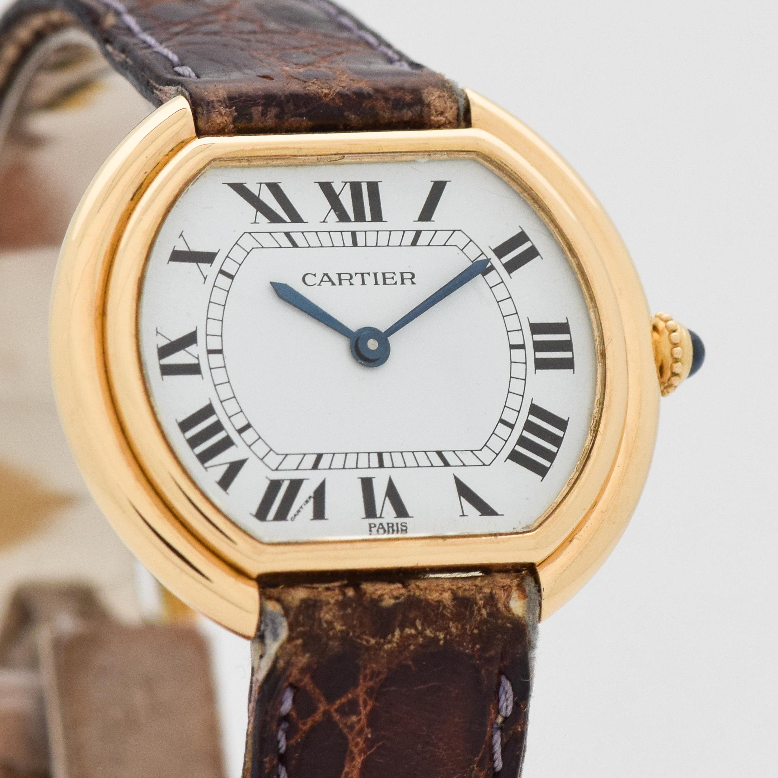 1990's Cartier Ellipse Gondole 18k Yellow Gold watch with Original White Dial with Black Roman Numeral with Original, Well-worn Cartier Crocodile Strap and Buckle. Suitable for a Man or a Woman. 32mm x 27mm lug to lug (1.26 in. x 1.06 in.) 17 jewel,