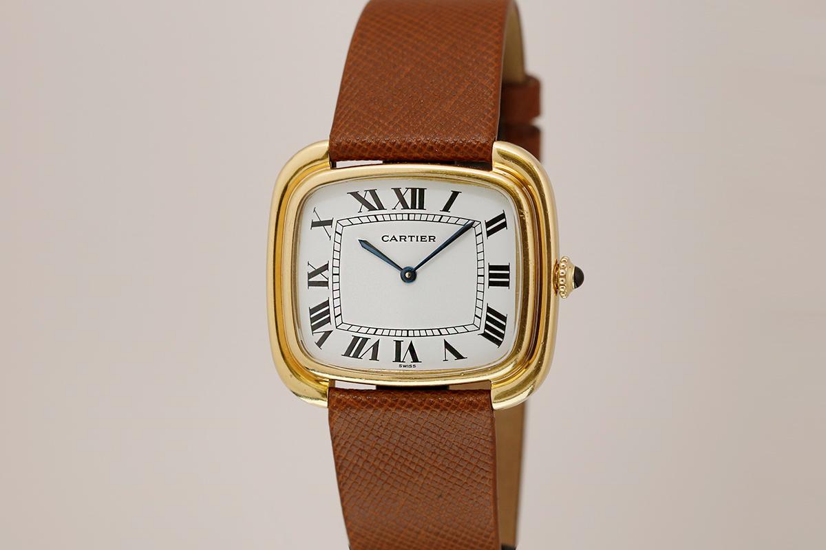 This Cartier Ellipse watch, known as the ' TV Screen', is from the 1970's and in 18k yellow gold. This large cased watch is in excellent condition with its hallmarks and serial number totally intact. The original white dial with black roman numbers