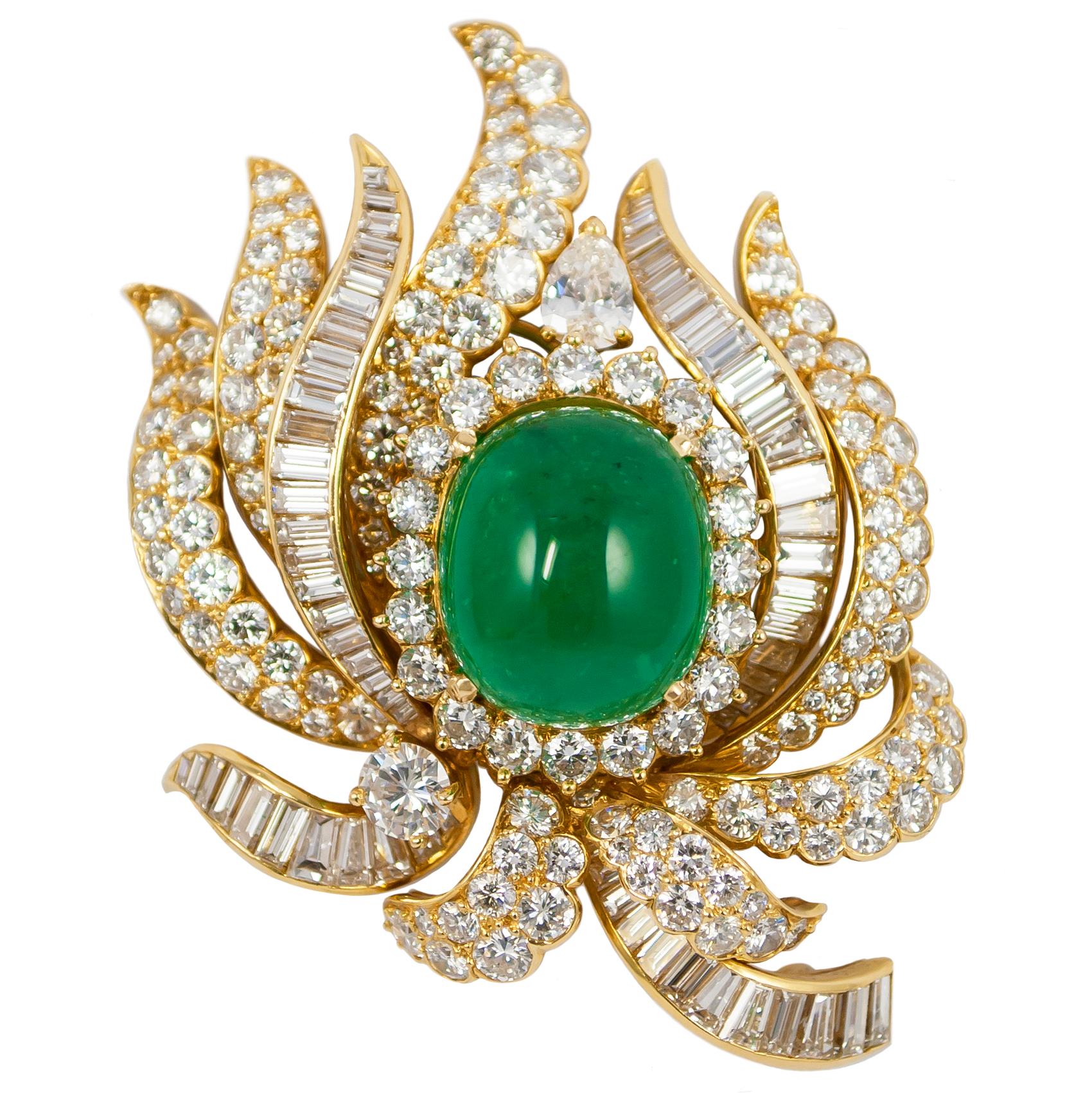 This magnificent signed Cartier brooch features a breathtaking Emerald cabochon bejeweled with scintillating diamonds... Set in rich 18K yellow gold, the craftsmanship of this piece is unparalleled; the juxtaposition of brilliant and step cut