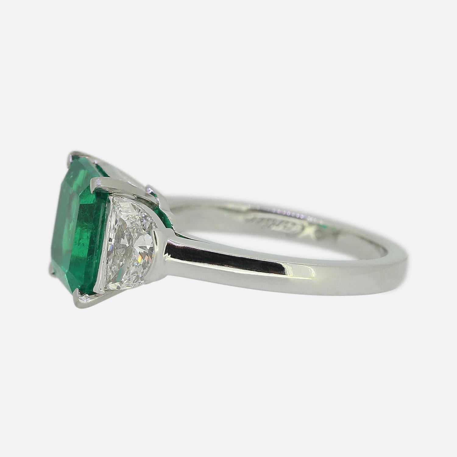 Here we have a outstanding emerald and diamond ring from the world renowned luxury jewellery house of Cartier. A fabulous square shaped Colombian emerald possessing a luscious vivid green colour tone sits at the centre of the face. This principle