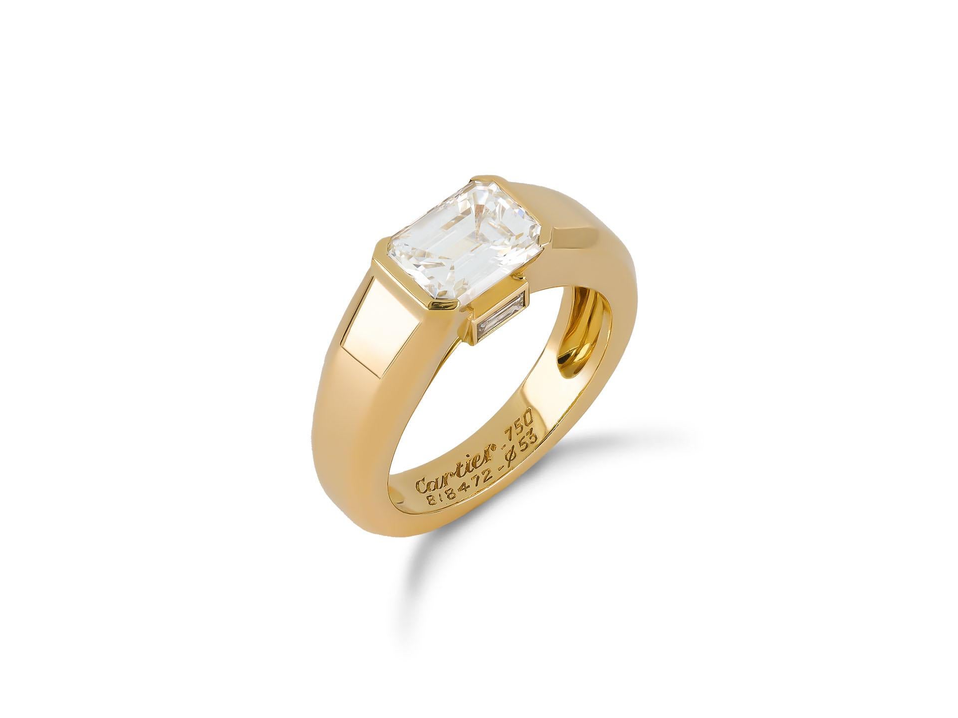 Cartier emerald-cut diamond solitaire. Set to centre with an octagonal emerald-cut diamond, G colour, VS1 clarity with a weight of 2.01 carats in an open back part-rubover setting, adorned by two rectangular baguette cut diamonds in open back