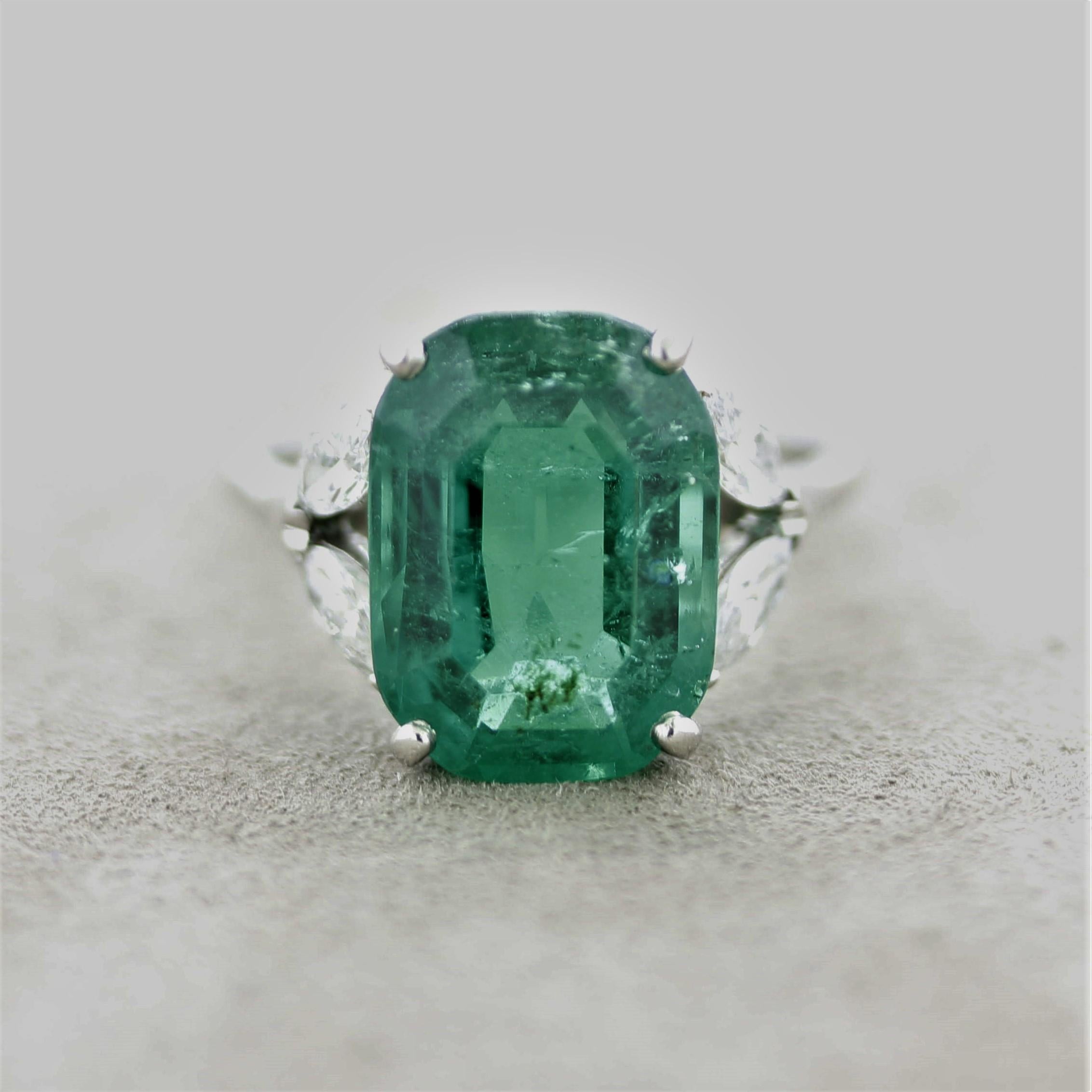 A majestic emerald takes center stage of this Cartier platinum ring. The emerald weighs 7.12 carats and has a bright vivid green color, a very fine quality stone. It is certified by the SSEF, the top gem lab in Switzerland, as natural with a Russian