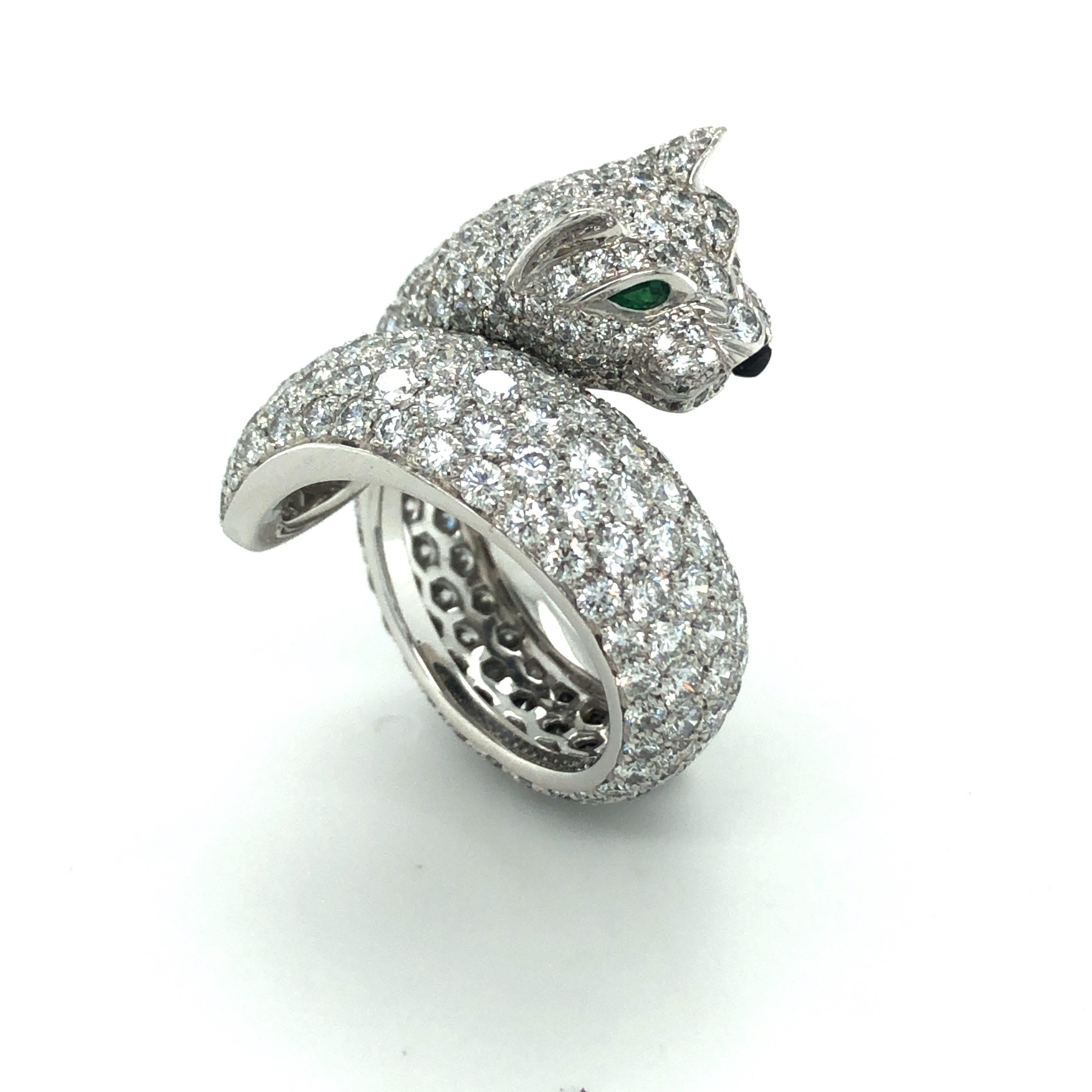 Magnificent Cartier emerald onyx diamond 18 karat white gold Lakarda Panthere ring.

This spectacular ring coils around the finger depicting the Maison's most iconic creature, the panther. It is crafted in 18 karat white gold and fully pavé-set with