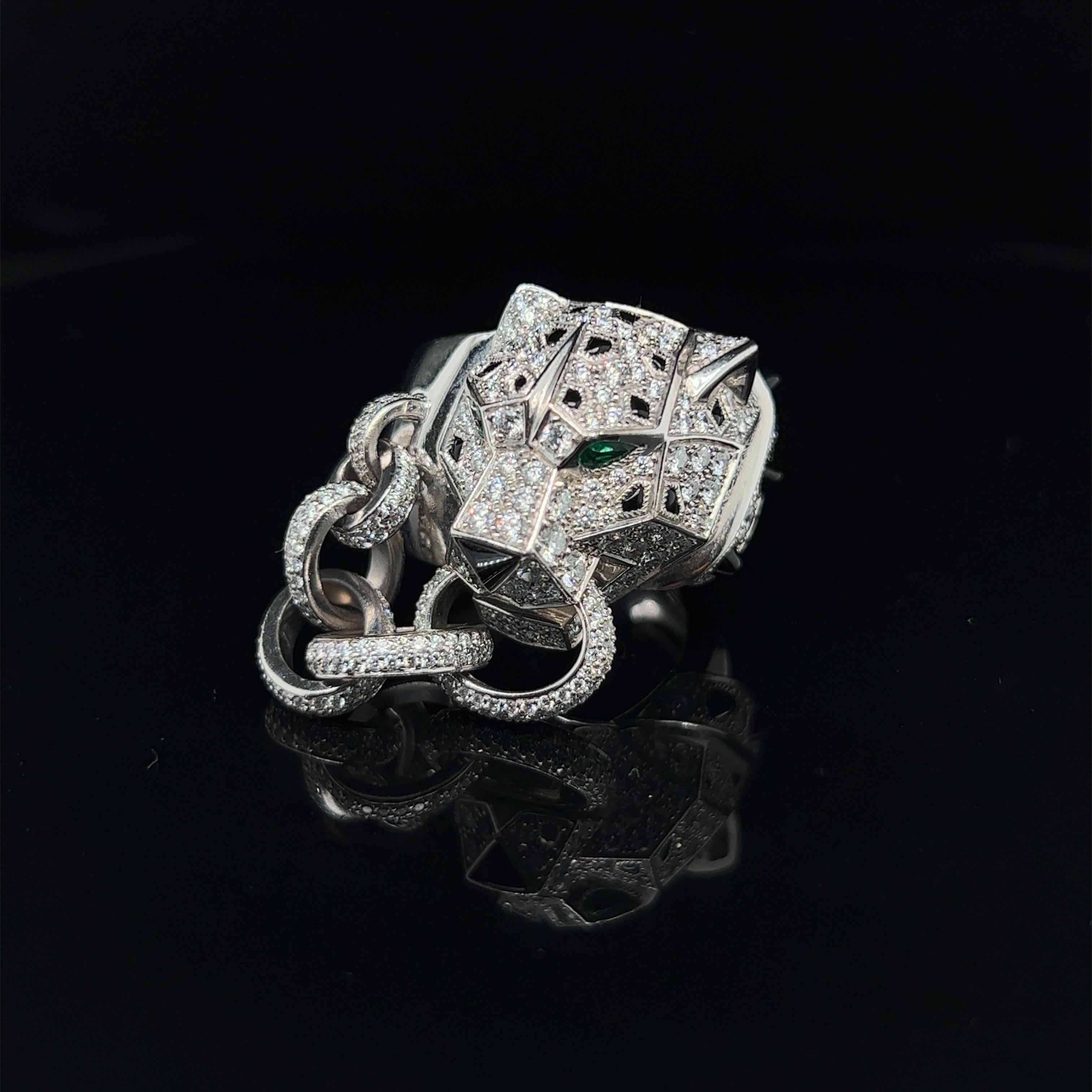 Magnificent emerald, onyx and diamond 18 karat white gold Panthère de Cartier ring, 2018.

This spectacular ring depicts the Maison's most iconic creature, the panther. It is crafted in 18 karat white gold, the head pavé-set with numerous