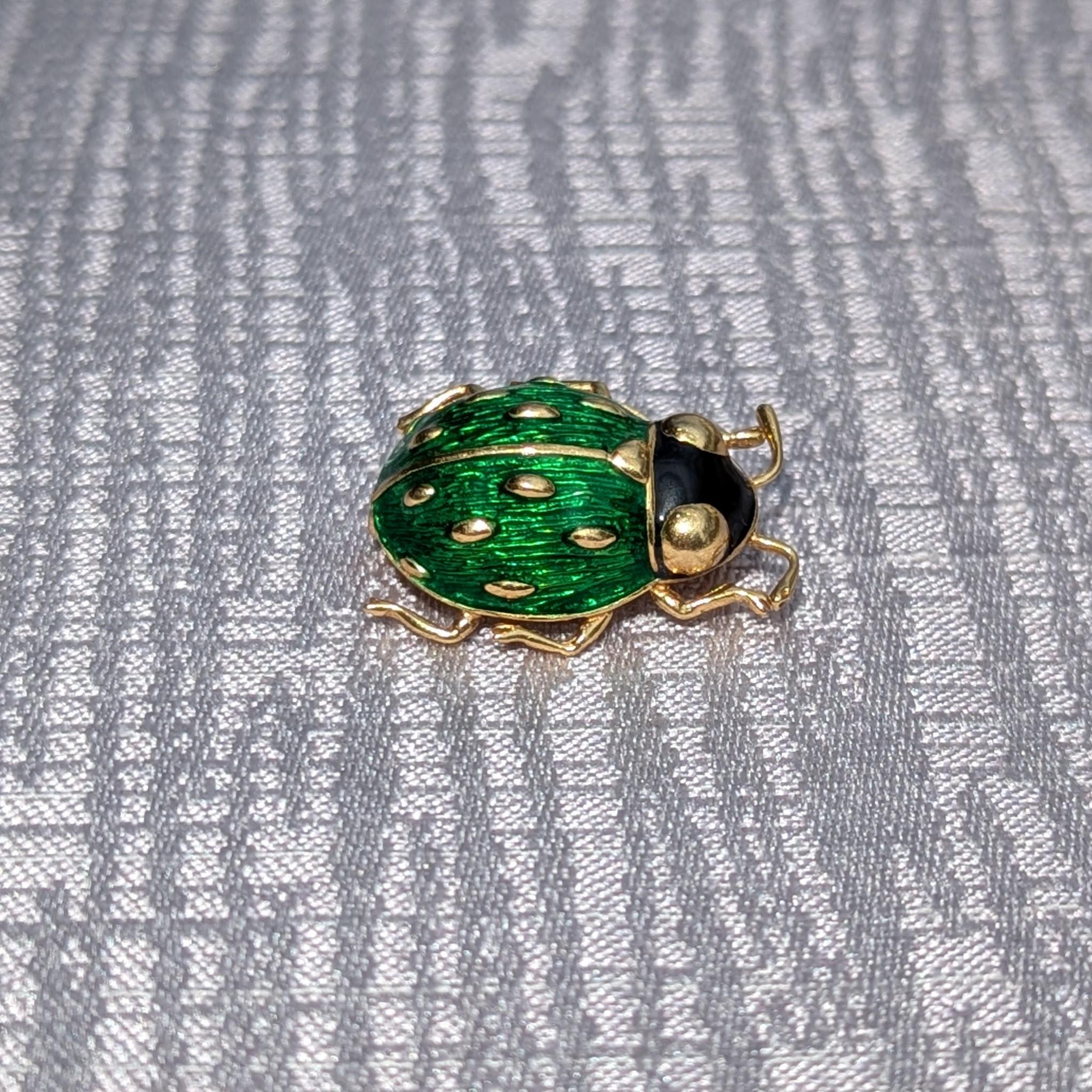 This beautiful pin is little, but loud. A beloved vintage Cartier, this Ladybug was designed with 18K Yellow Gold and Enamel, creating an eye-catching green and black enamel ladybug.

This piece is signed 