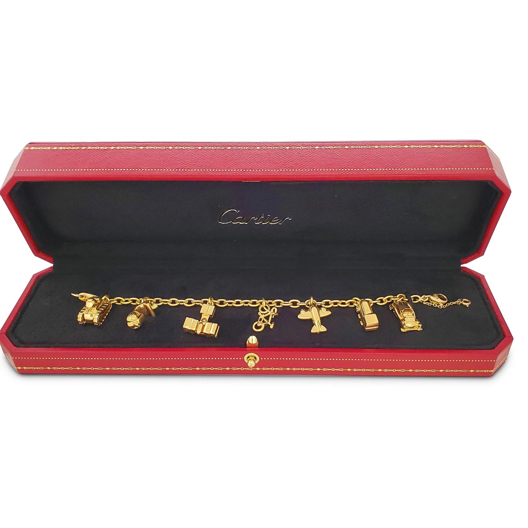 Authentic Cartier 'À Thème Manège' or 'Merry-Go-Round' charm bracelet crafted in 18 karat yellow gold. The bracelet features a delightful assortment of charms, including a tank, a scooter, two planes, a bicycle, a train, and a car. 

Bracelet