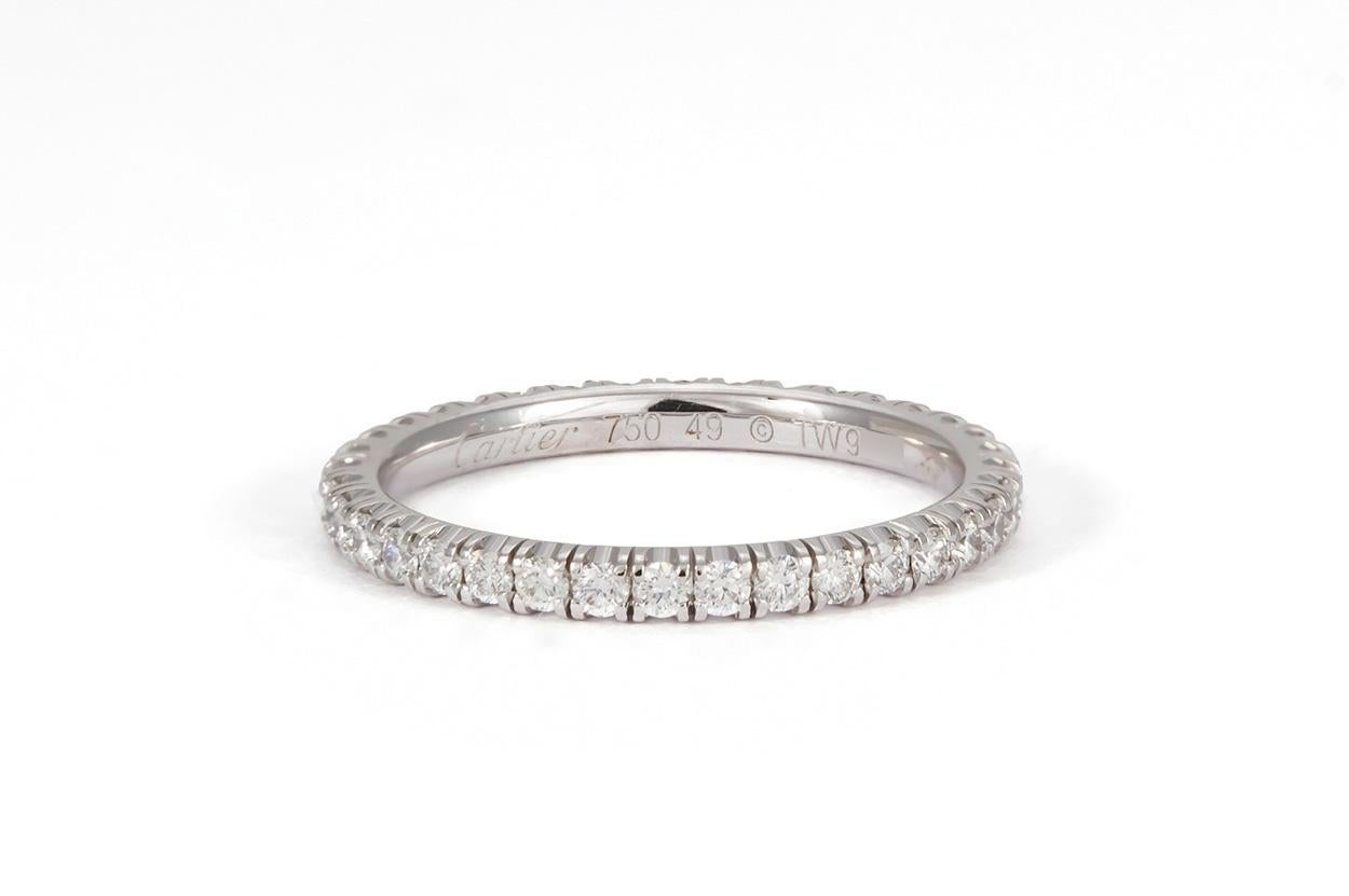 We are pleased to offer this Authentic Cartier Étincelle 18k White Gold & Diamond Eternity Wedding Band. It features 0.47ctw D-F/VVS-VS Round brilliant Cut Diamond set in 18k White Gold. It is a size 4.75 US (49 EU)and measures 2mm wide. It comes