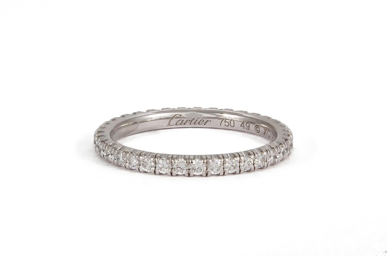 We are pleased to offer this Authentic Cartier Étincelle 18k White Gold & Diamond Eternity Wedding Band. It features 0.47ctw D-F/VVS-VS Round brilliant Cut Diamond set in 18k White Gold. It is a size 4.75 US (49 EU)and measures 2mm wide. It comes