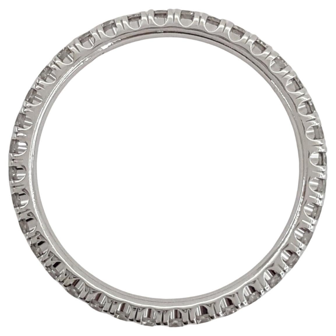 An Eternity Band Ring from Cartier, named ÉTINCELLE DE Cartier, showcases a French Pave Set with 0.45 ct Round Diamonds in a full circle design, set in 18K White Gold. Weighing 1.7 grams and sized 4.75 (French 49), the ring has dimensions of 2 mm in