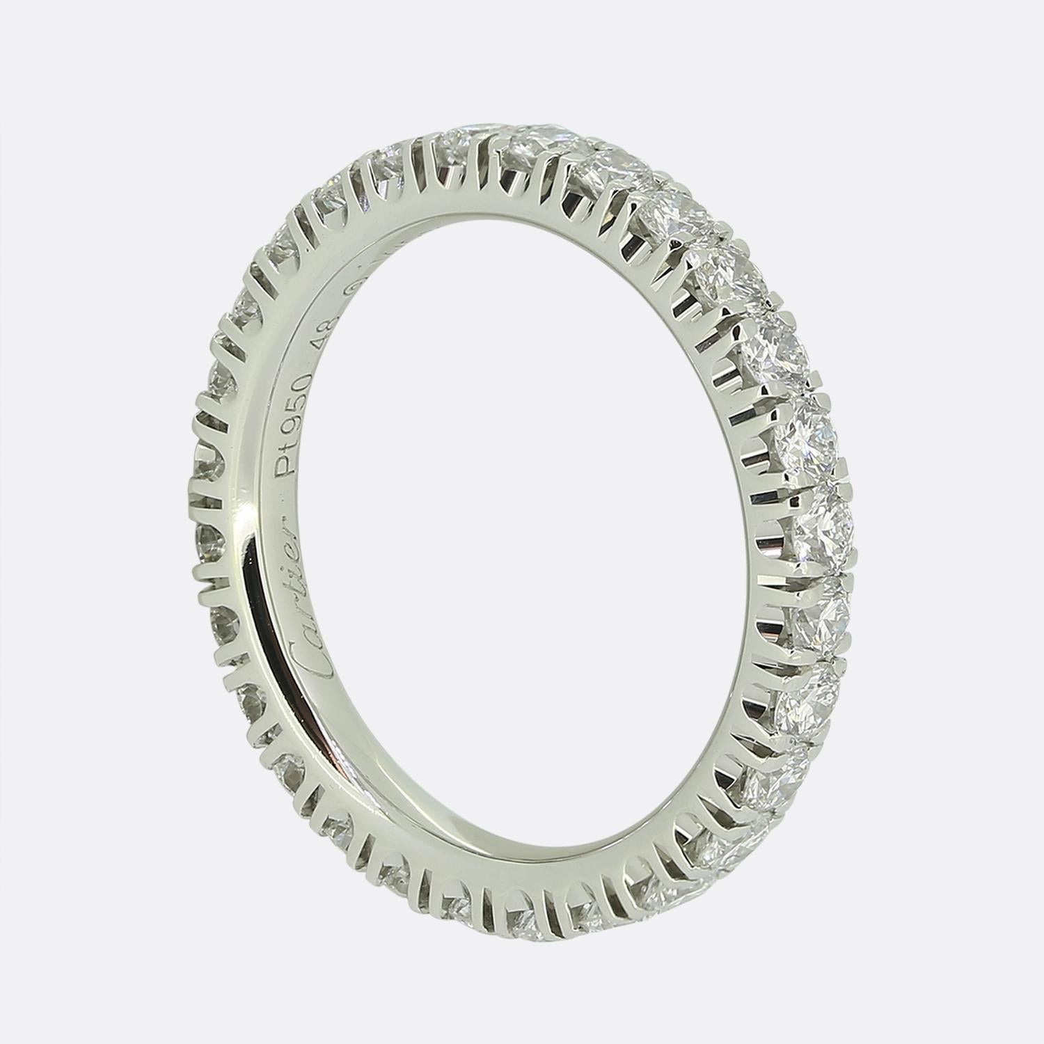 Here we have a platinum band ring adorned with a continuous row of brilliant-cut white diamonds from the world renowned luxury jewellery house of Cartier. Each stone has been closely claw set creating a seamless sparkle when wrapped around the