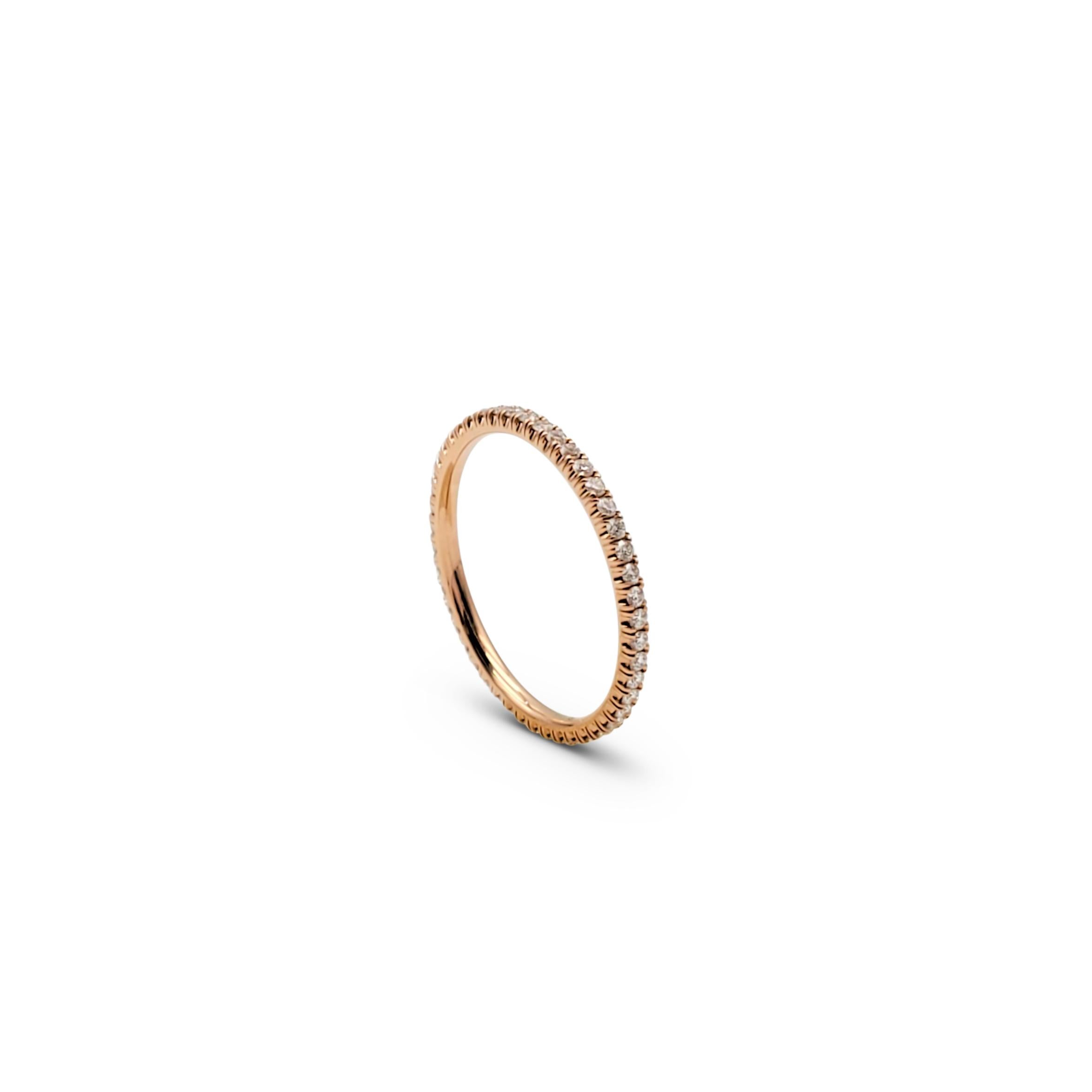 Authentic Cartier 'Étincelle de Cartier' wedding band crafted in 18 karat rose gold, set with round brilliant cut diamonds (E-F, VS) totaling 0.22 carats. Signed Cartier, 50, Au750, with serial number. Ring size 50 (US 5 1/4). The ring is presented