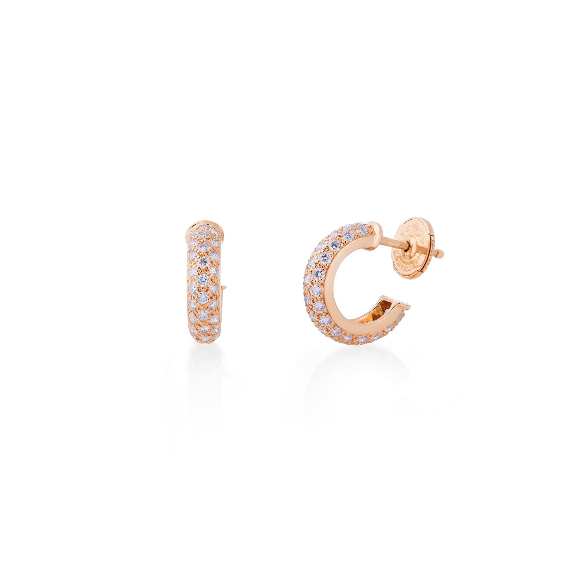 Authentic Cartier Étincelle de Cartier huggie hoop earrings crafted in 18 karat yellow gold and set with approximately 0.75 carats of high quality round cut diamonds.  The earrings measure .54 inches long and .15 inches wide.  Signed Cartier, 750,