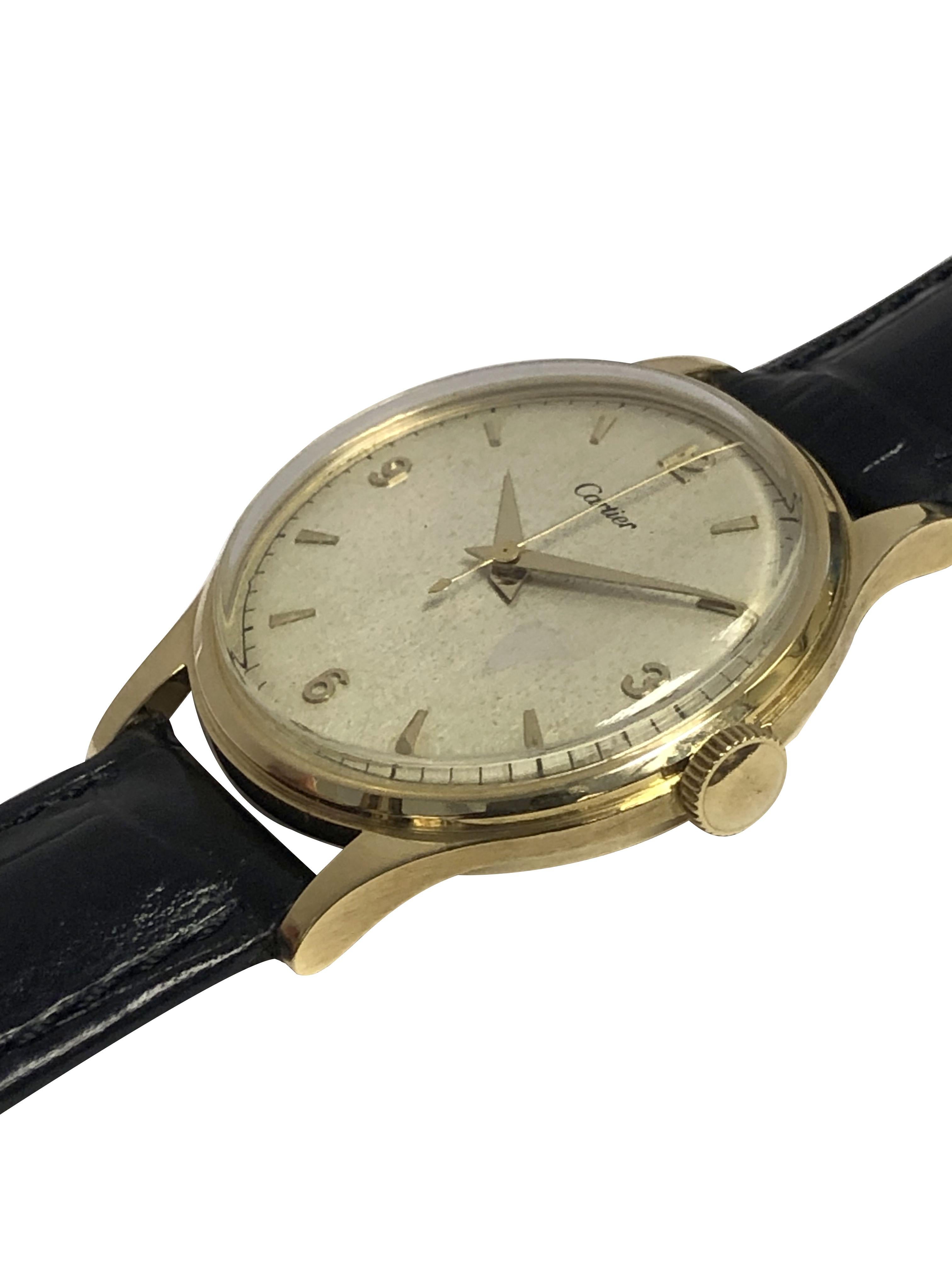 Circa 1954 Cartier Wrist Watch, 36.5 M.M 18k Yellow Gold 2 piece Cartier numbered case with water resistant back. 17 Jewel, Mechanical, Manual wind Caliber P4504C EWC, European Watch and Clock Co. movement. Silver Satin dial with raised Gold