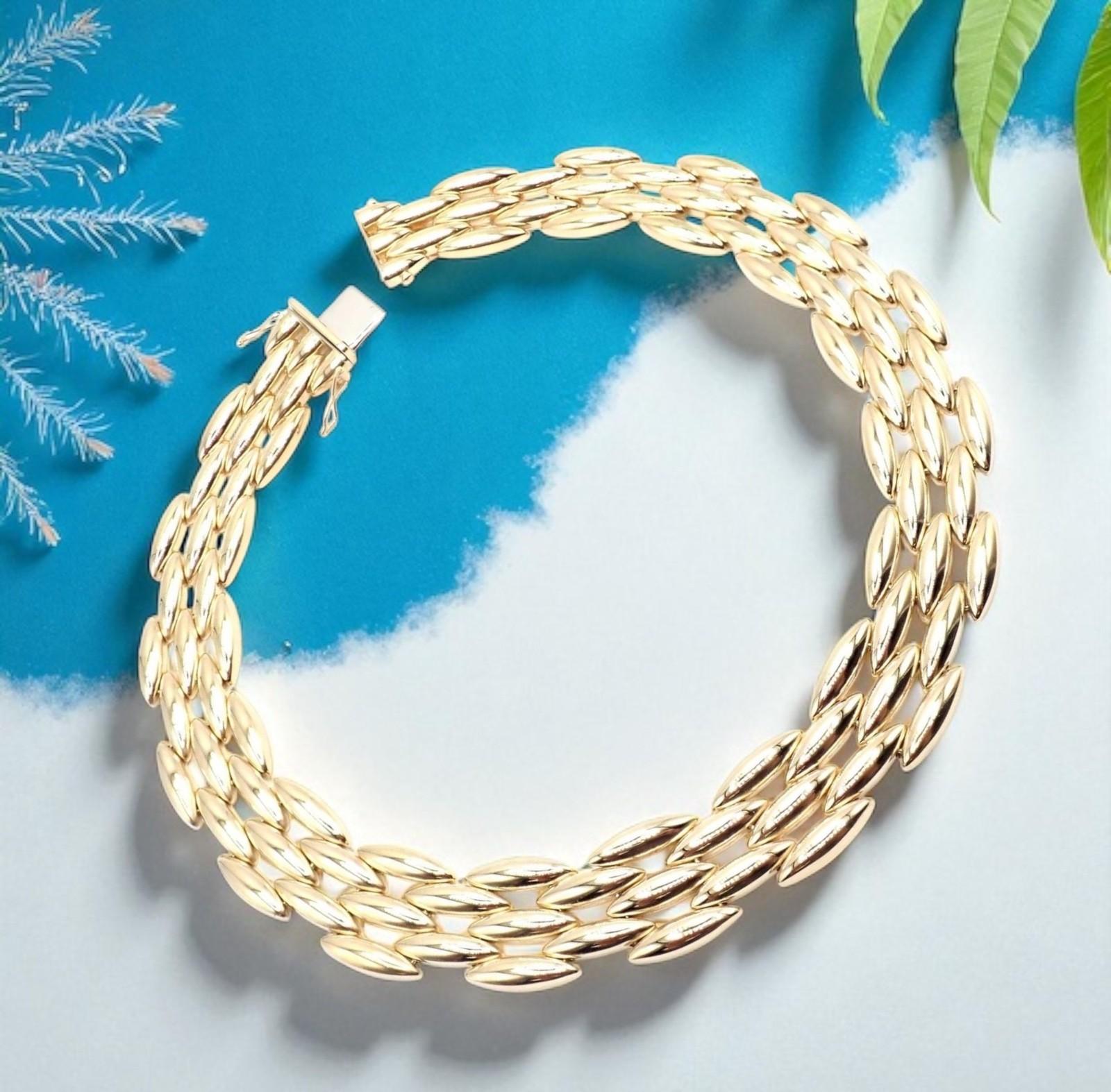 18k Yellow Gold Gentiane Five Row Rice Wide  Link Necklace by Cartier. 
This authentic Cartier Gentiane necklace features five luxurious rows of 18k yellow gold rice-shaped links in a bold, wide design. 
Known for its elegant fluidity and