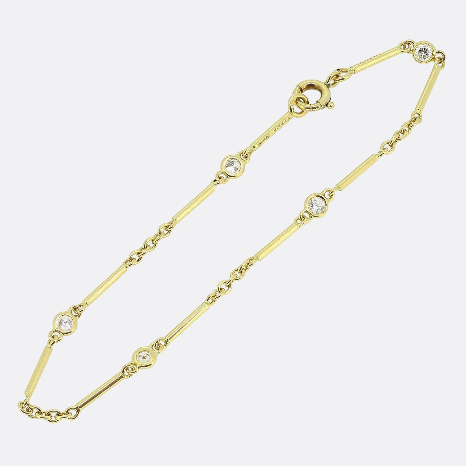 Here we have an sleek and stylish 18ct yellow gold bracelet from the world renowned luxury jewellery house of Cartier. The design incorporates smooth slender gold bars linked by small chains, each adorned with a bright white round brilliant cut