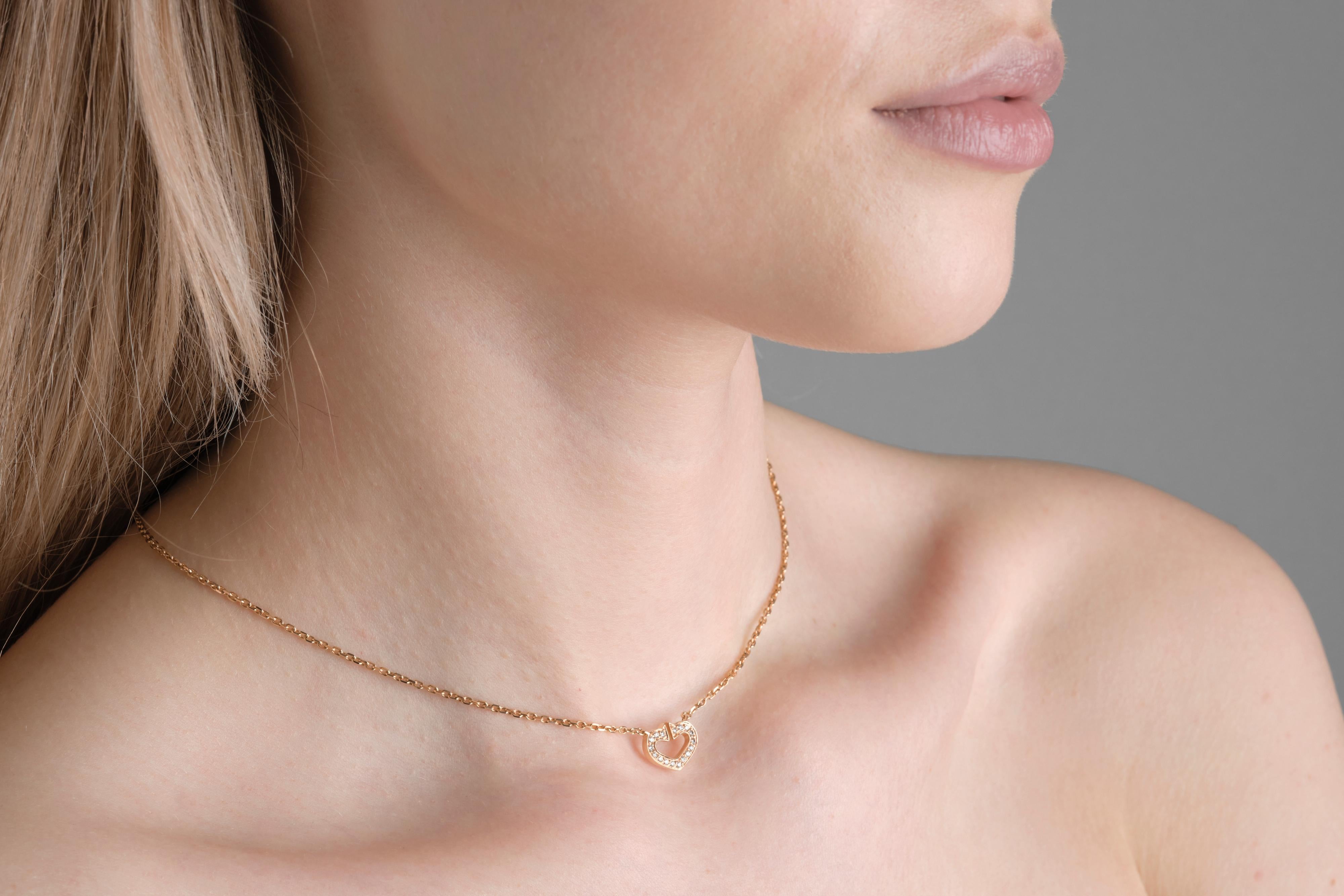 Cartier 

C de Heart Necklace 

Diamonds on 18K Yellow Gold 

Reversible - can be worn as a plain gold necklace if preferred


Necklace total length is 15.5” or 39cm

Excellent Condition

Presented in its Original Cartier Necklace box
