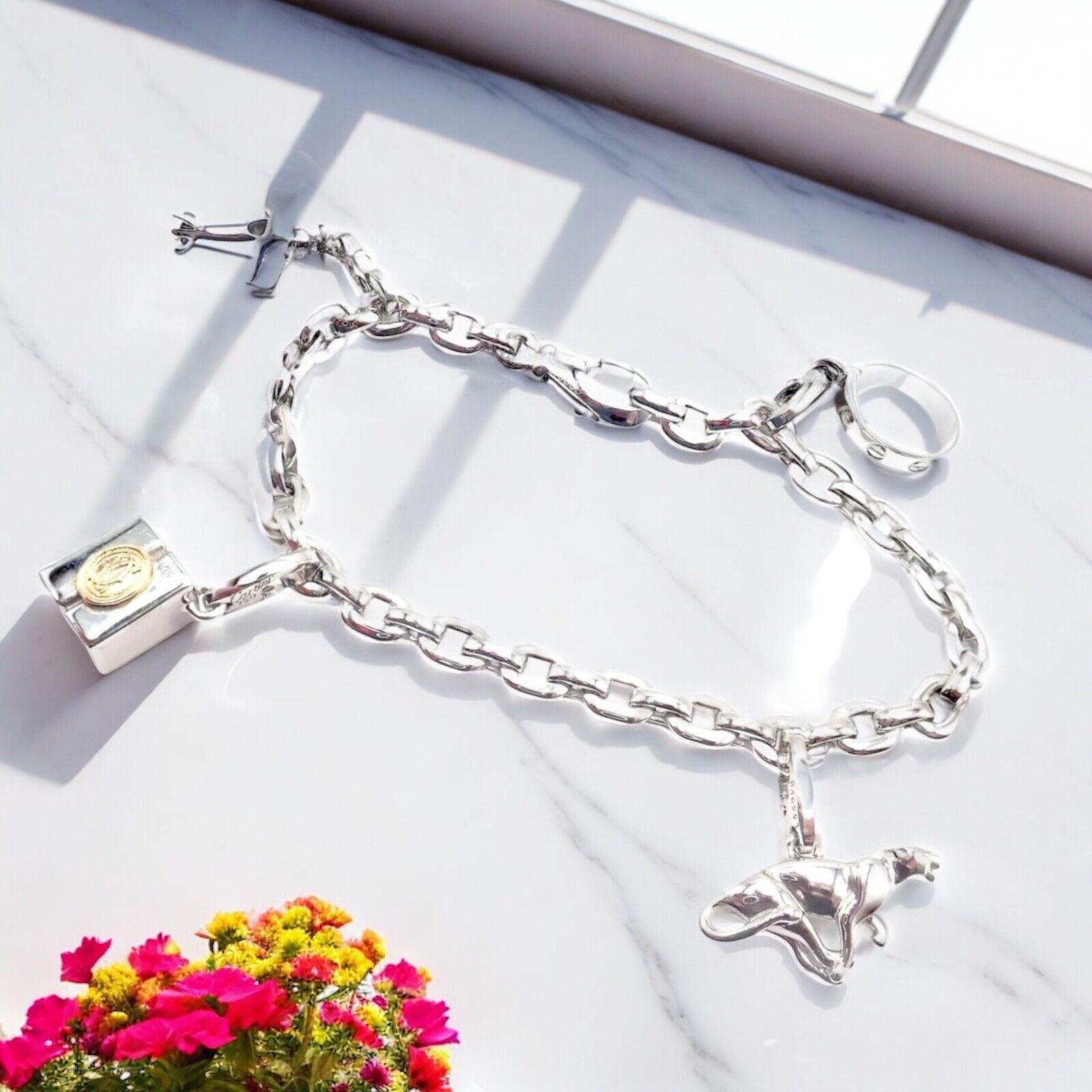 18k White Gold Four Charms Airplane Baby Love Panther Gift Box Link Bracelet by Cartier.
The Cartier 18k White Gold Bracelet features four charms: a panther, an airplane, a Love motif, and a box link design. 
Each charm showcases Cartier's exquisite