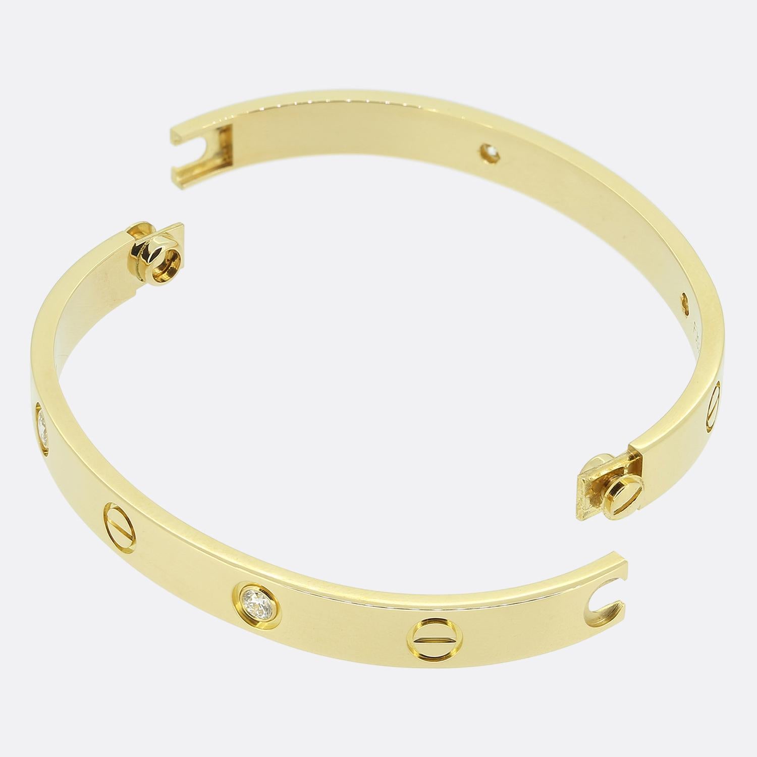 This is an 18ct yellow gold bangle from the world renowned luxury jewellery house of Cartier. This bangle forms part of the LOVE collection and features four round brilliant cut diamonds alongside the iconic screw motif.

