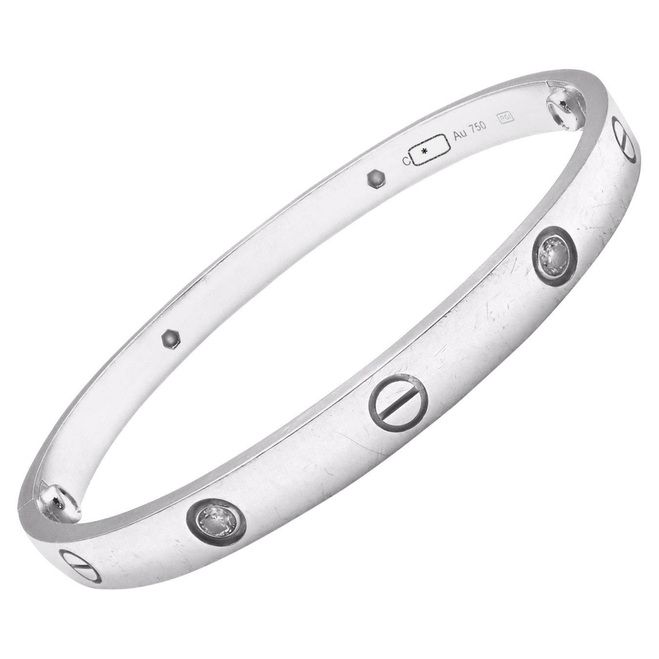 18k White Gold 4 Diamond Cartier LOVE Bangle Bracelet, size 19 with New Screw System!
With 4 brilliant round cut diamonds, VS1 clarity, E-F color total weight approx. .20ct
This bracelet comes with a Cartier box, screwdriver and a certificate of