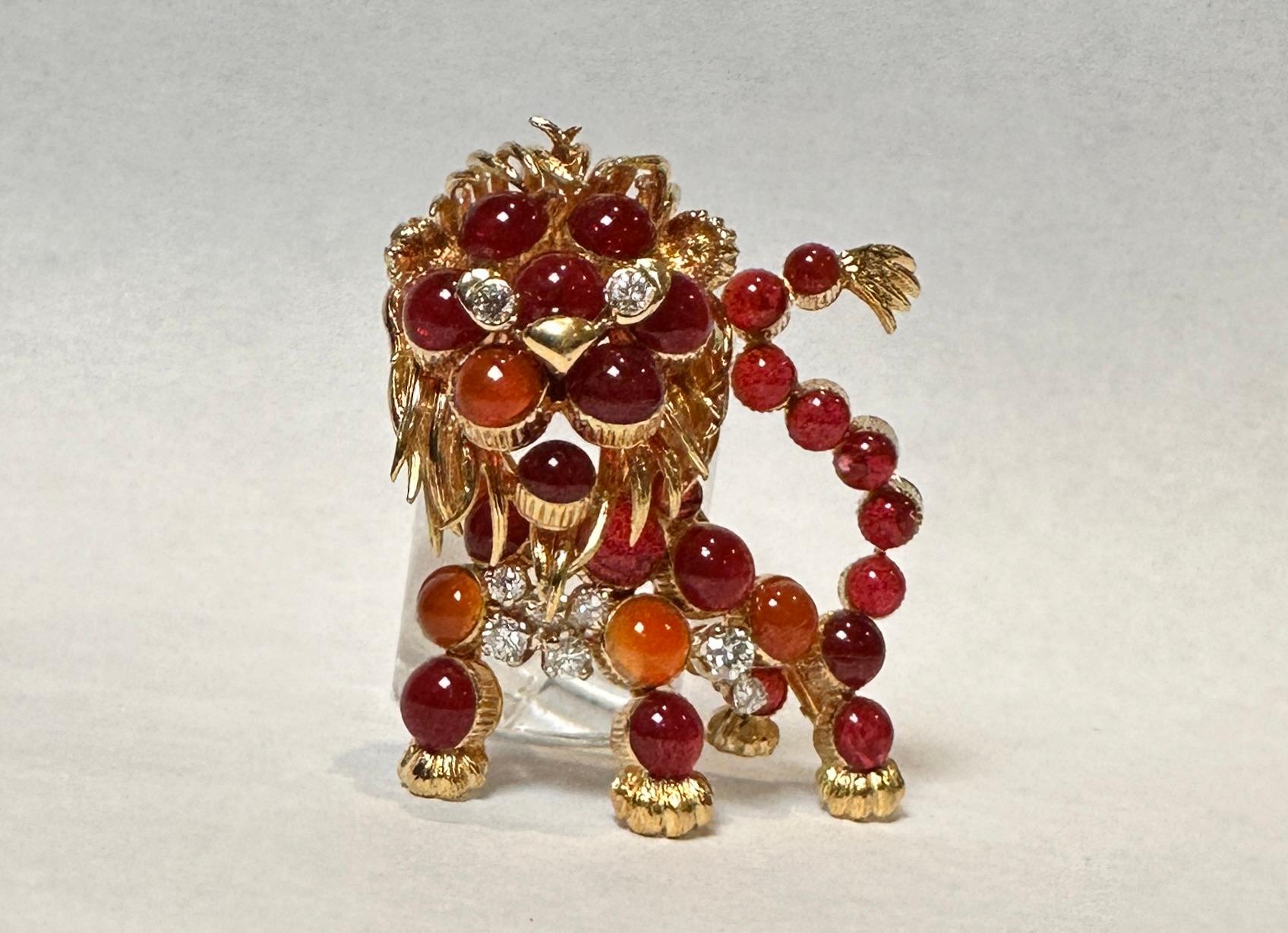 Circa 1960s Cartier France 18K yellow gold whimsical and unusual Lion Brooch. Hand chased and detailed gold work and set with round cabochon carnelian stones and further set with diamonds. Having a double pin clip fastener. Signed, numbered and