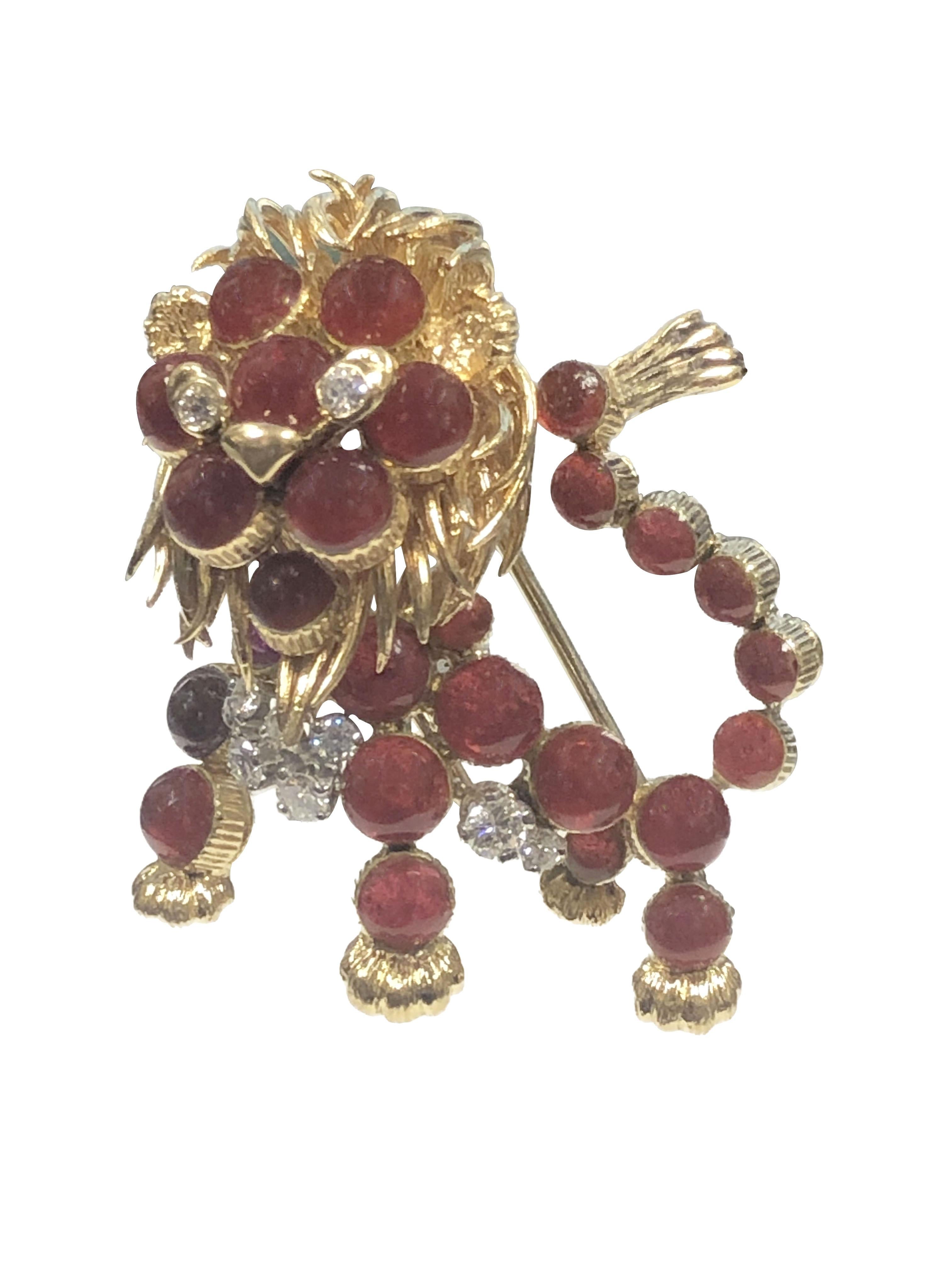 Circa 1960s Cartier France 18K yellow Gold Whimsical Lion Brooch, Measuring 1 3/8 inches X 1 3/4 inches. Hand Chased and detailed Gold work and set with Round Cabochon Red Glass stones and Further set with Diamonds. Having a Double pin Clip