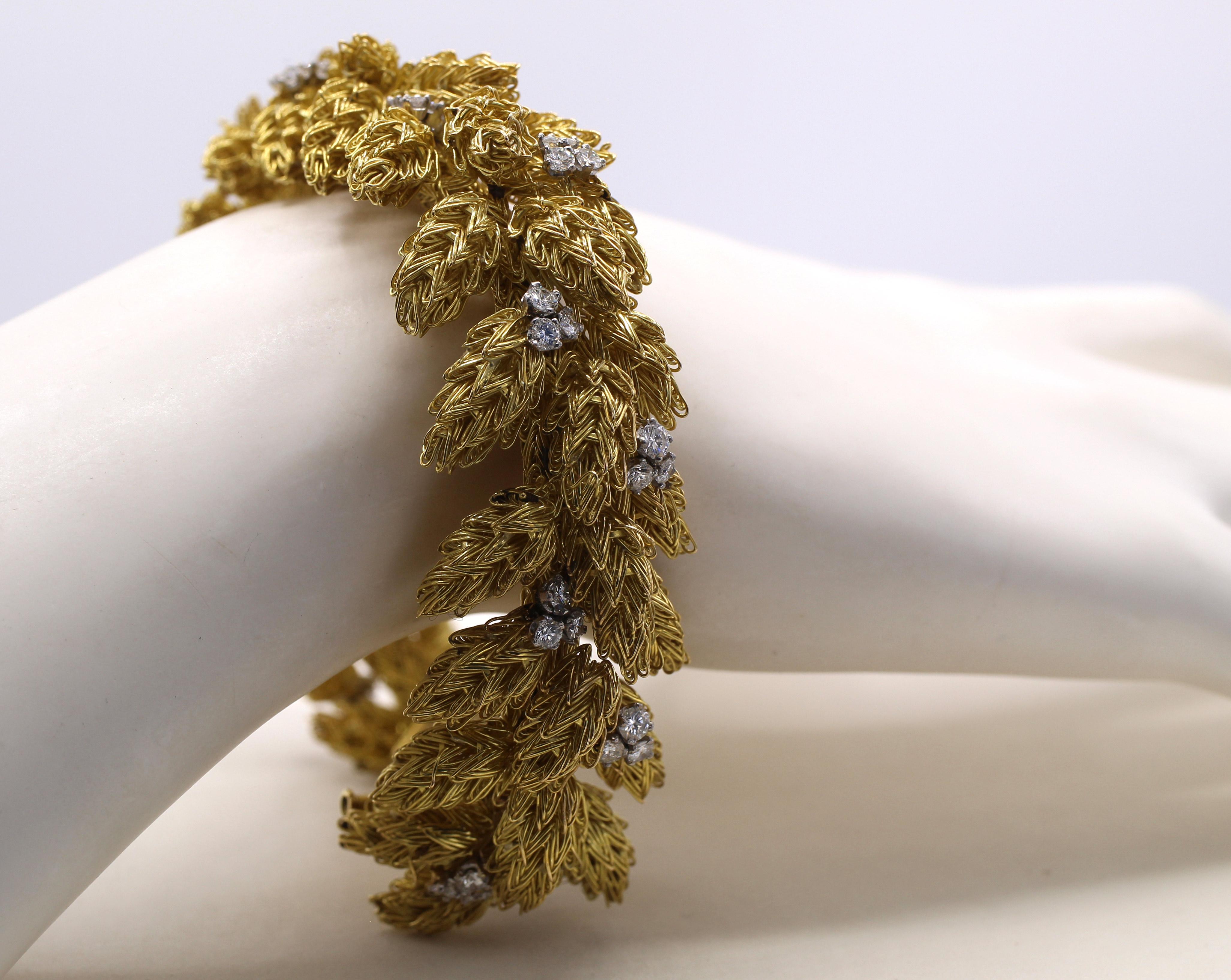 Magnificently designed and exceptionally well handcrafted this unique 1970s bracelet has been fashioned to appear like a bed of feathers on the wrist. Literally thousands of fine handcrafted gold wires have been assembled into 48 elements on various