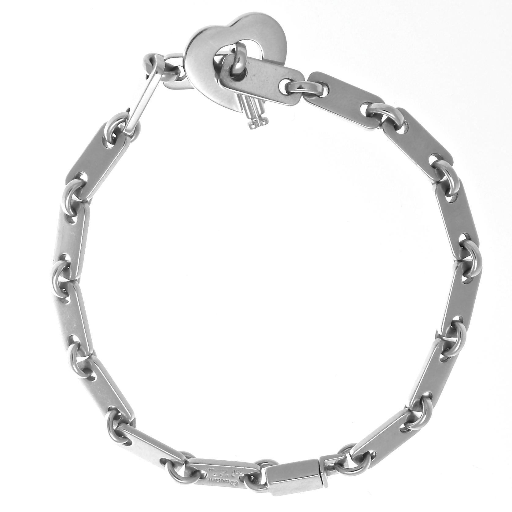 The perfect 18k white gold link bracelet with a beautiful open heart clasp, from Cartier France. Circa 1997, and measures 7 1/4 inches long. Signed Cartier and includes serial numbers. Add to your wrist stack or wear it alone, but wear it everyday