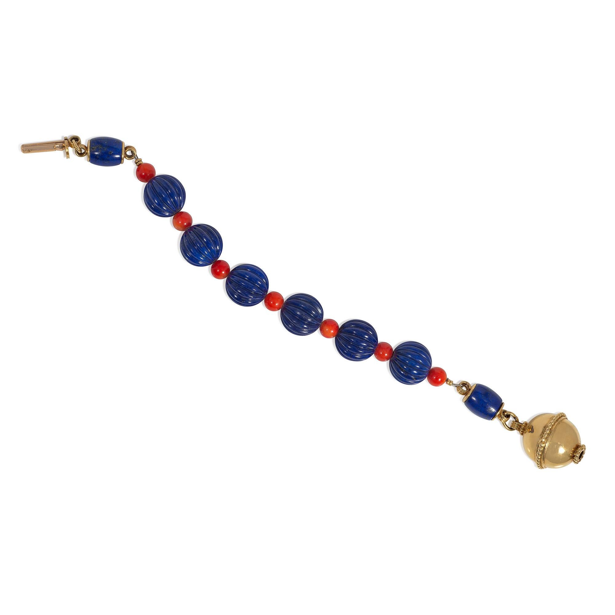 A mid-century lapis, coral, and gold bracelet comprised of fluted lapis beads alternating with smaller red-orange coral beads, terminating in barrel-shaped lapis links and a granulated gold bead clasp, in 18k.  Cartier, France.  #06636.
Fluted lapis