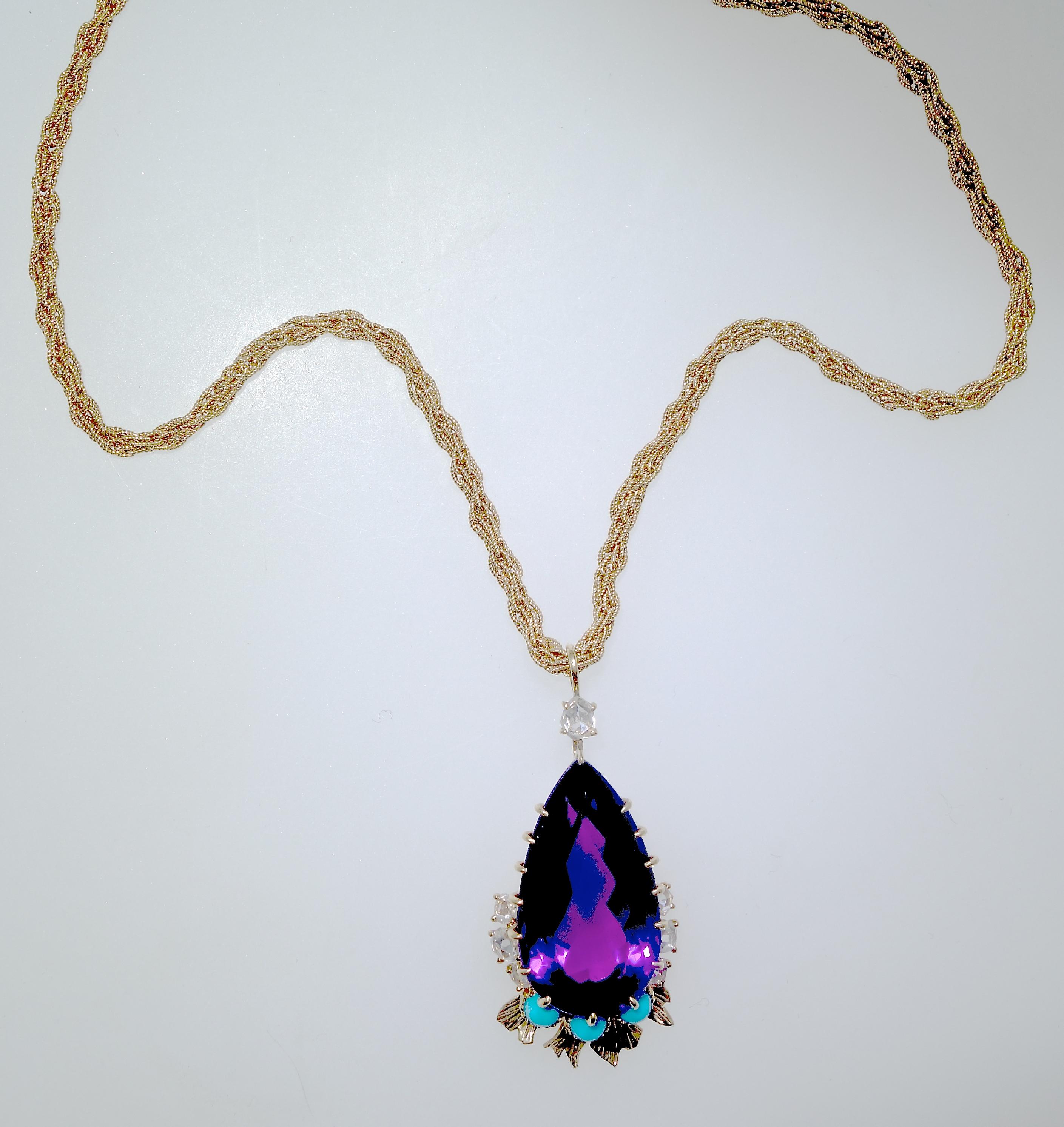 Cartier has set a very fine natural Siberian amethyst as a tear drop, accented with rose cut diamonds and Persian Turquoise from a Cartier 18K gold chain.  This center stone which has wonderful flashes of red - a hallmark of fine amethysts from