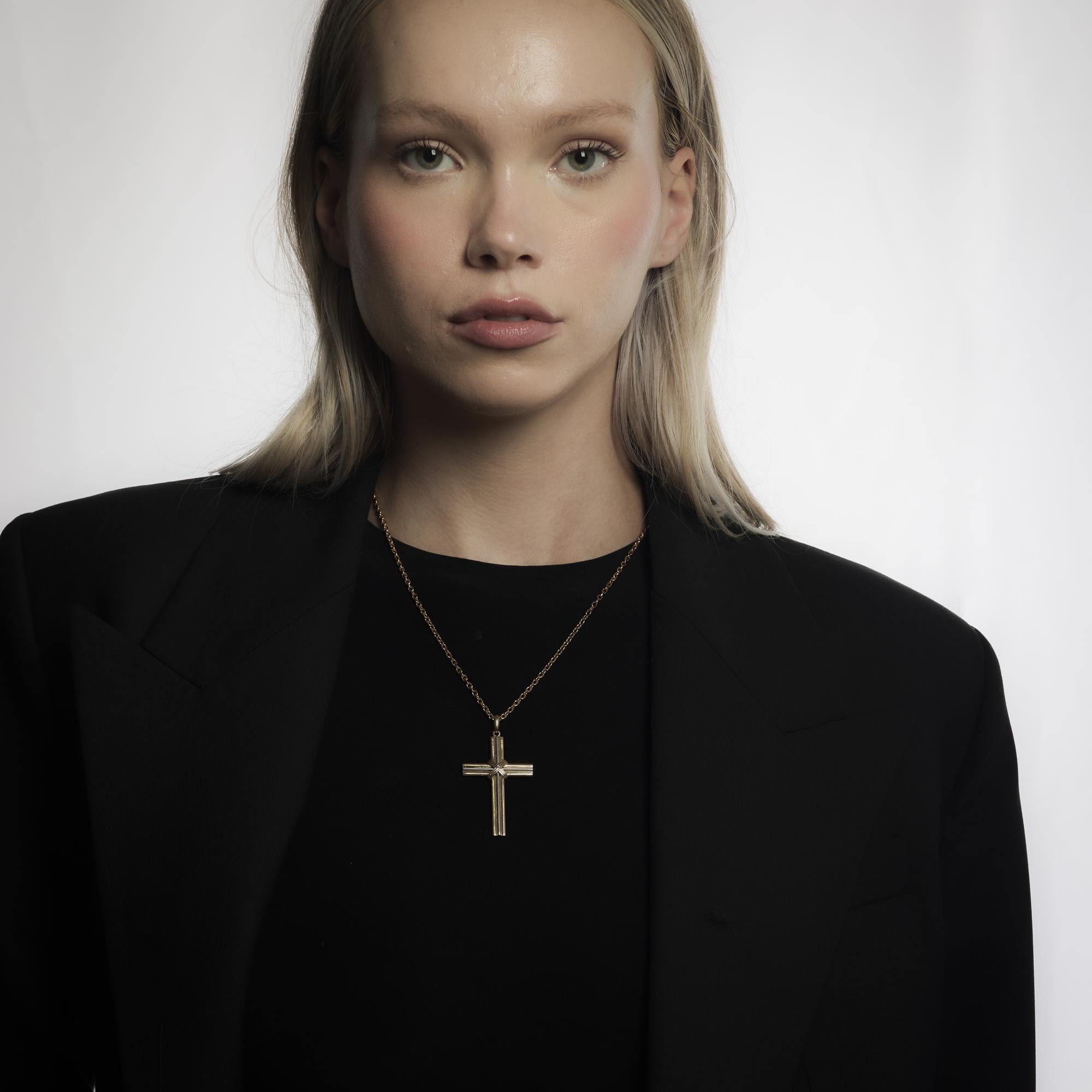 This vintage Cartier necklace from the 1980’s features a striking 18k tricolor gold cross pendant paired with a rich 18k yellow gold chain. The bold interplay of white, yellow, and rose gold in the pendant creates dimension and visual interest,
