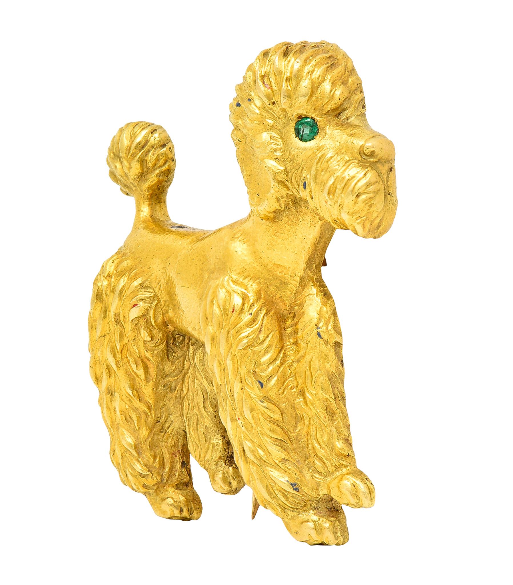 Designed as a highly rendered standing poodle with deeply textured fur
Accented by a flush set round cut emerald eye
Transparent bright medium green in color
With matte finish throughout
Completed by hinged double pin stem
Stamped 18KTS for 18 karat