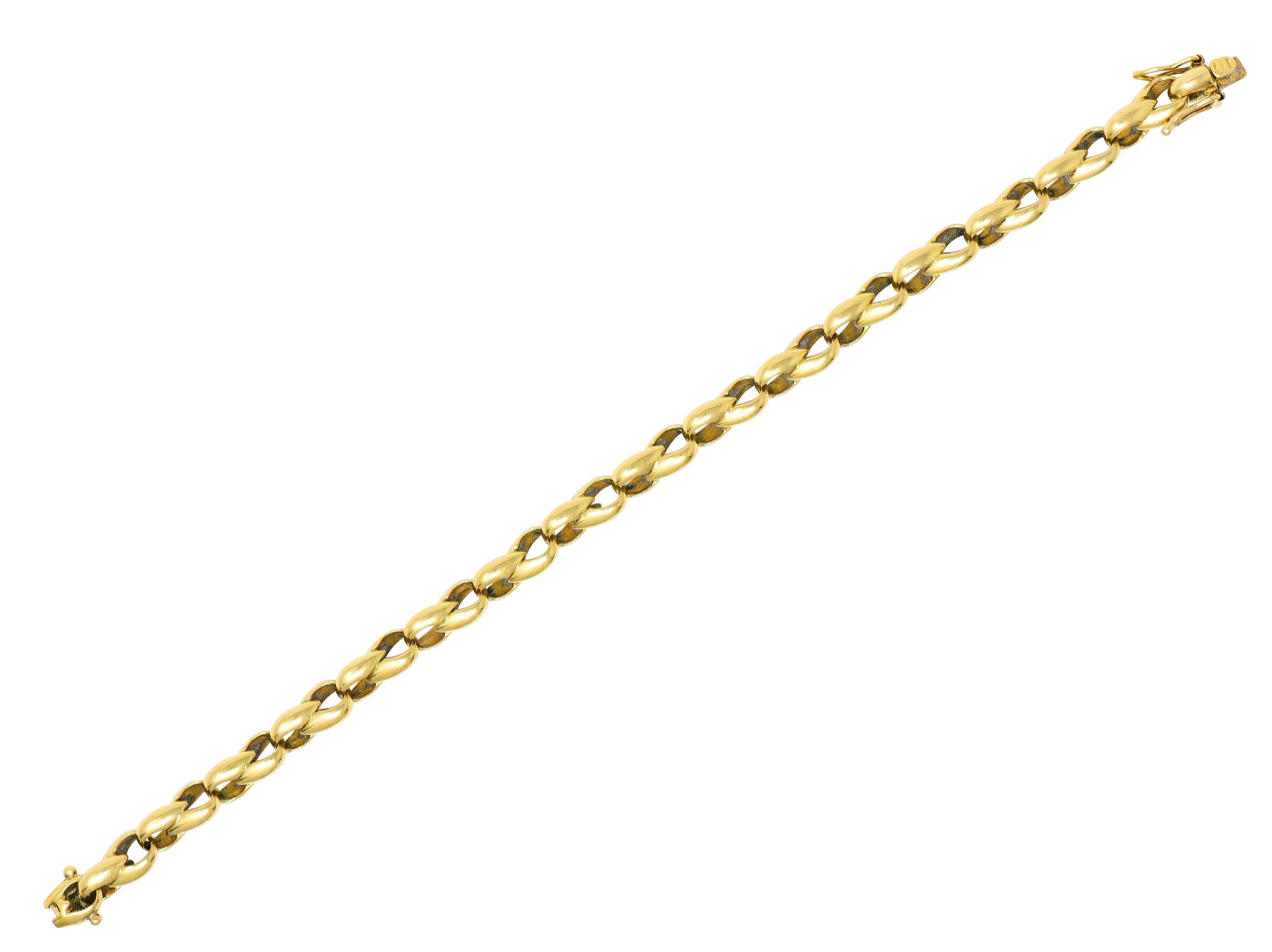 Designed as an infinity link chain 
With solid faceted pear links 
Completed by concealed clasp closure 
With hinged double figure eight safety 
Stamped with French hallmarks for 18 karat gold
Numbered and fully signed for Cartier
Circa: 1991; via