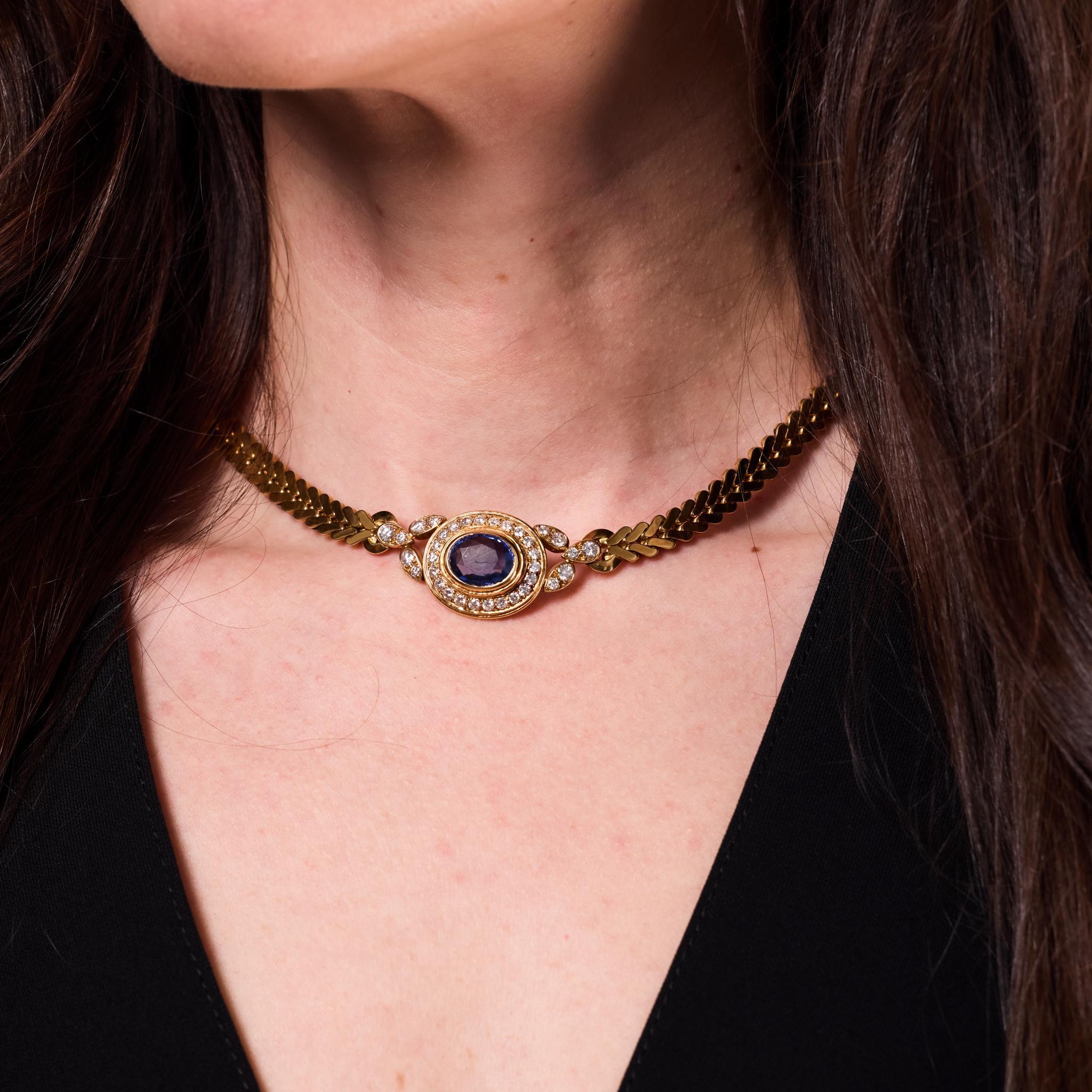 Crafted in the 1980s, this vintage Cartier necklace is an exquisite display of refined elegance and iconic design. Centered by an oval cut blue sapphire weighing approximately 4.80 carats, the necklace is accented by 34 round brilliant cut diamonds