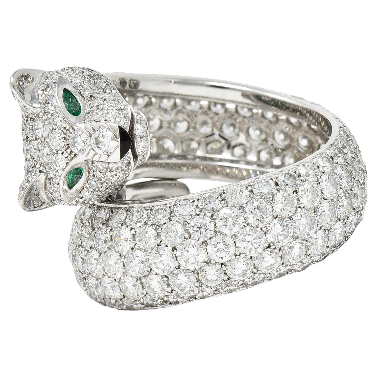 Bypass ring is designed as a stylized panther motif that wraps finger

Pavè set throughout by round brilliant cut diamonds

Weighing in total approximately 6.50 carats - E/F color with VVS to VS clarity

With pear cut emerald eyes weighing in total