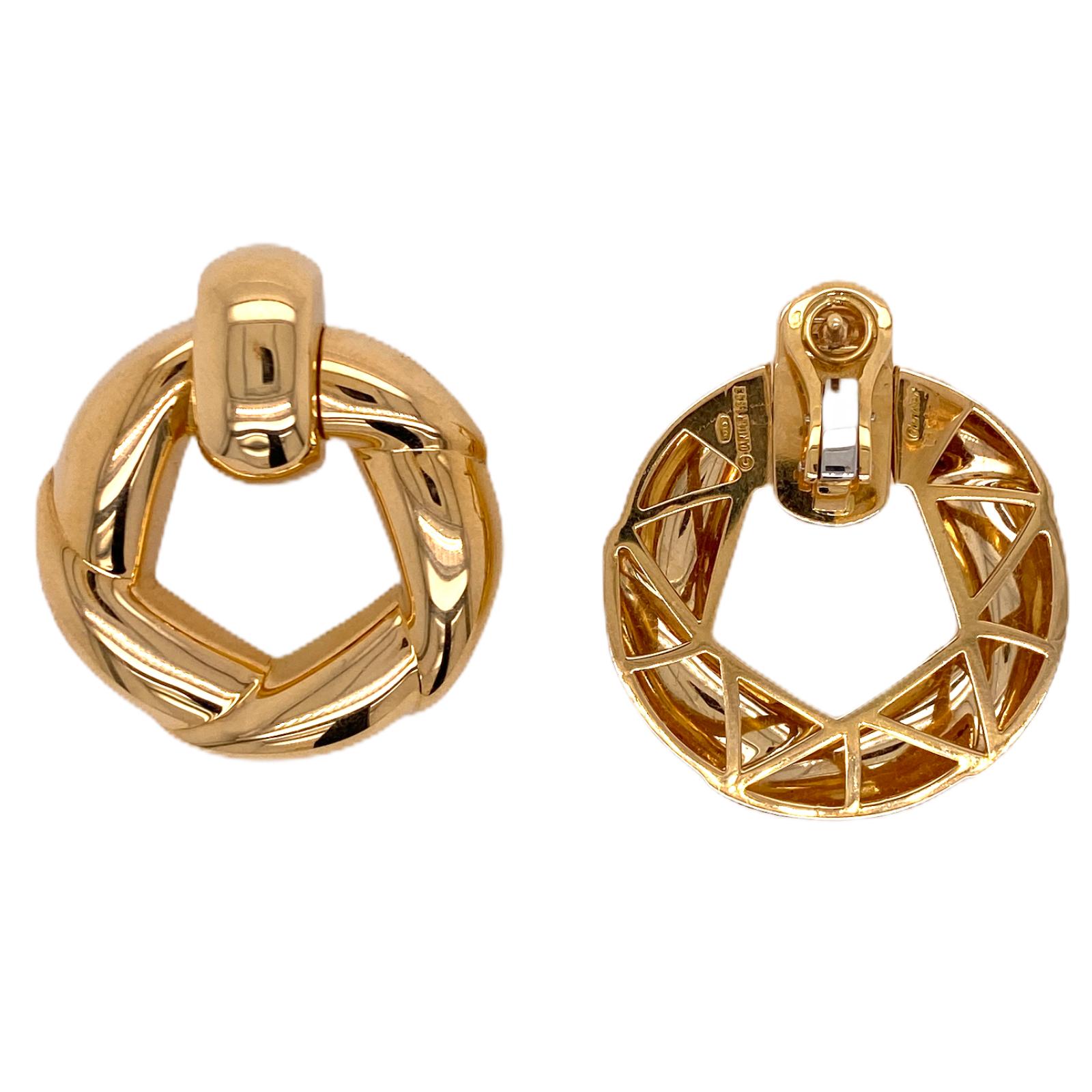 Fabulous 18 karat yellow gold door knocker earrings crafted by Cartier. The earrings are circa 1993, are beautifully crafted, and feature omega backs. The earrings measure 1.25 inches in width, and 1.50 inches in length. Signed Cartier 1993 750 and