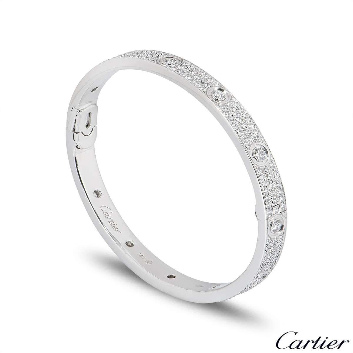 An exquisite 18k white gold Cartier diamond bracelet from the Love collection. The bracelet has 10 round brilliant cut diamonds around the outer edge in a rubover setting with 206 round brilliant cut diamonds pave set between each larger diamond.
