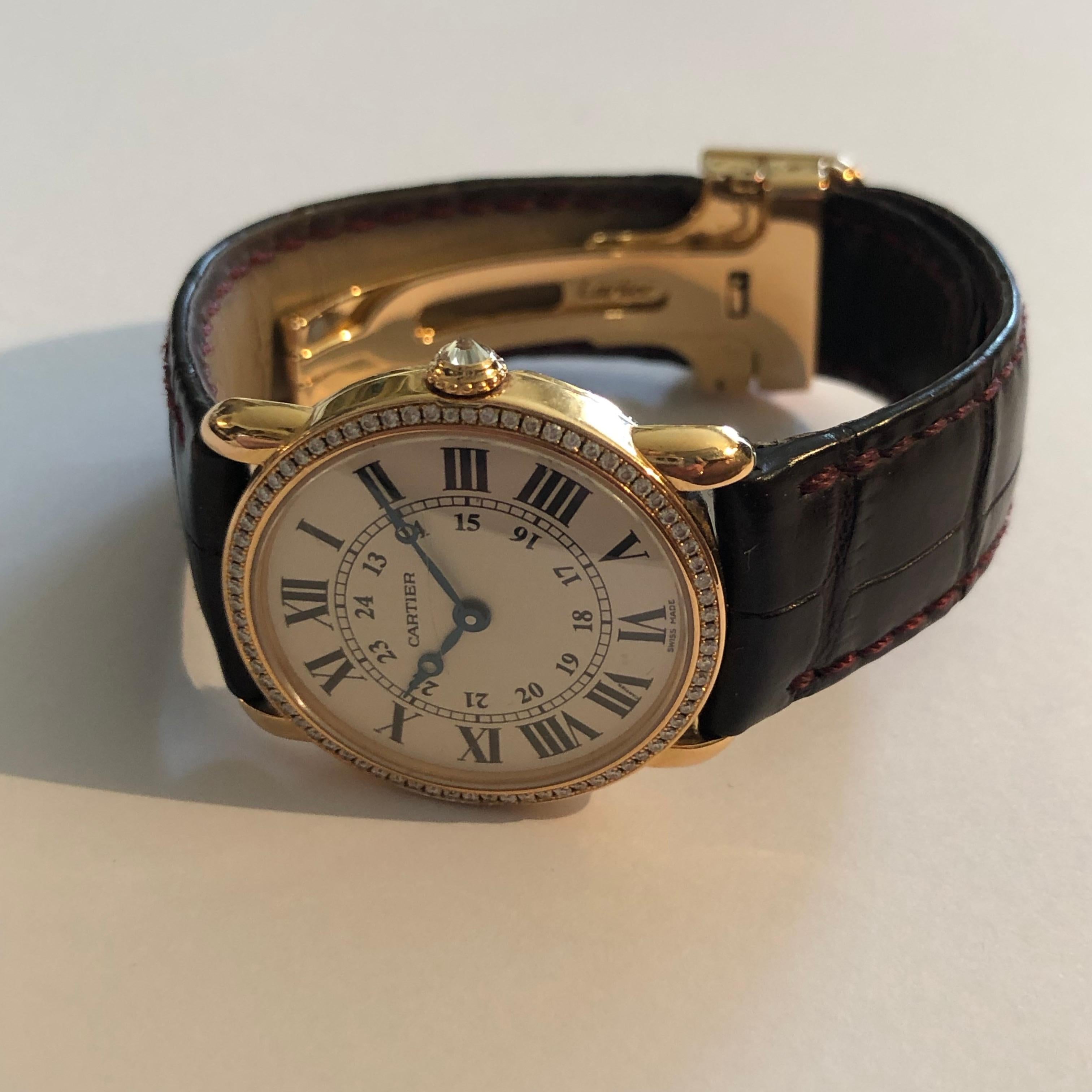 Watch Ronde Louis Cartier 29mm by Cartier rose gold (case, and buckle) - diamond crowned and diamonds cased. 

Signed, numbered and stamped.

Quartz working movement. Bracelet has a bit worn. One little scratche on glass.
Model still on sale on