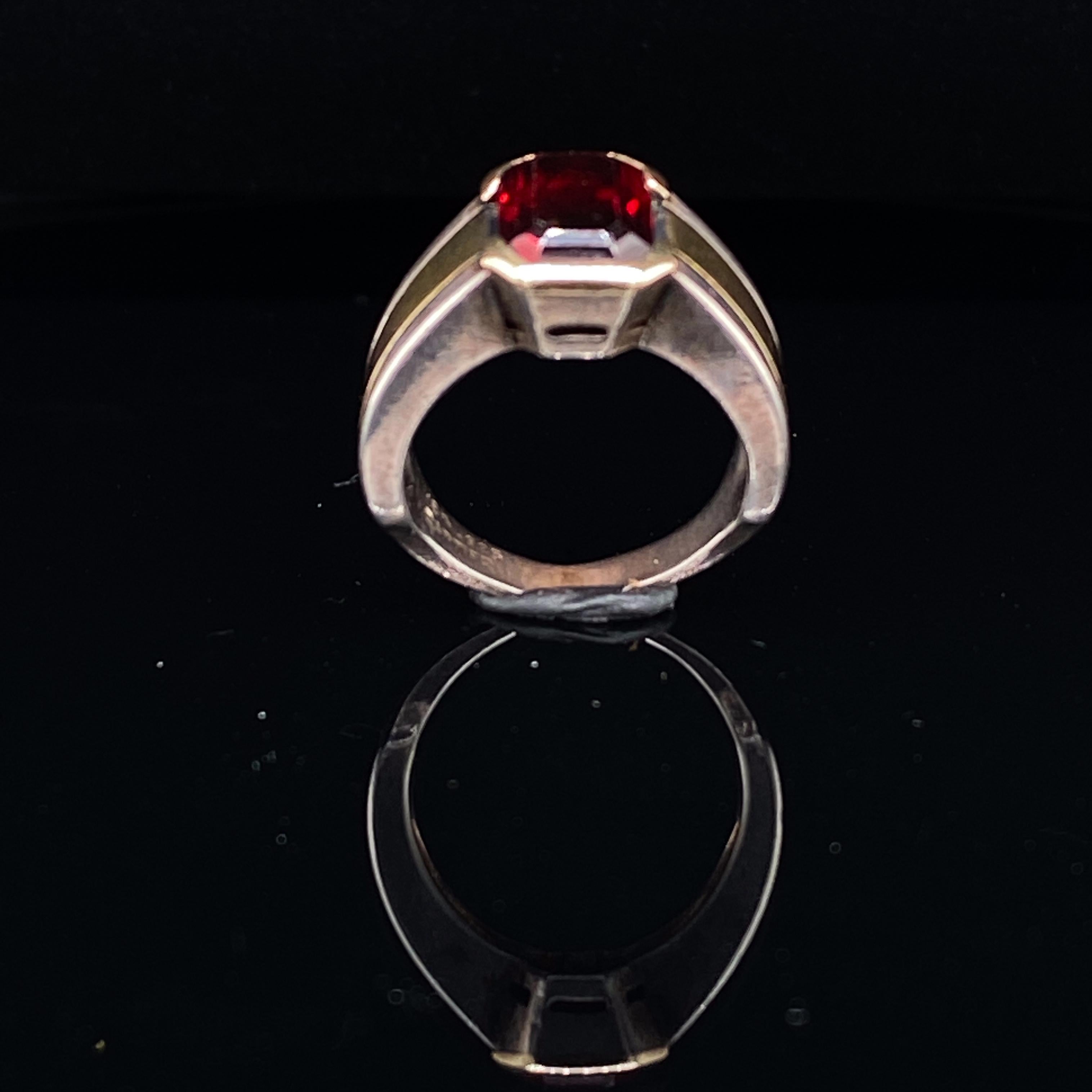 Cartier garnet ring in two-tone silver and 18 karat yellow gold, circa 1990.

An incredibly wearable finely crafted Cartier ring in Sterling Silver and 18 Karat yellow gold featuring an emerald cut garnet to its centre.

The garnet is 1.50 carat