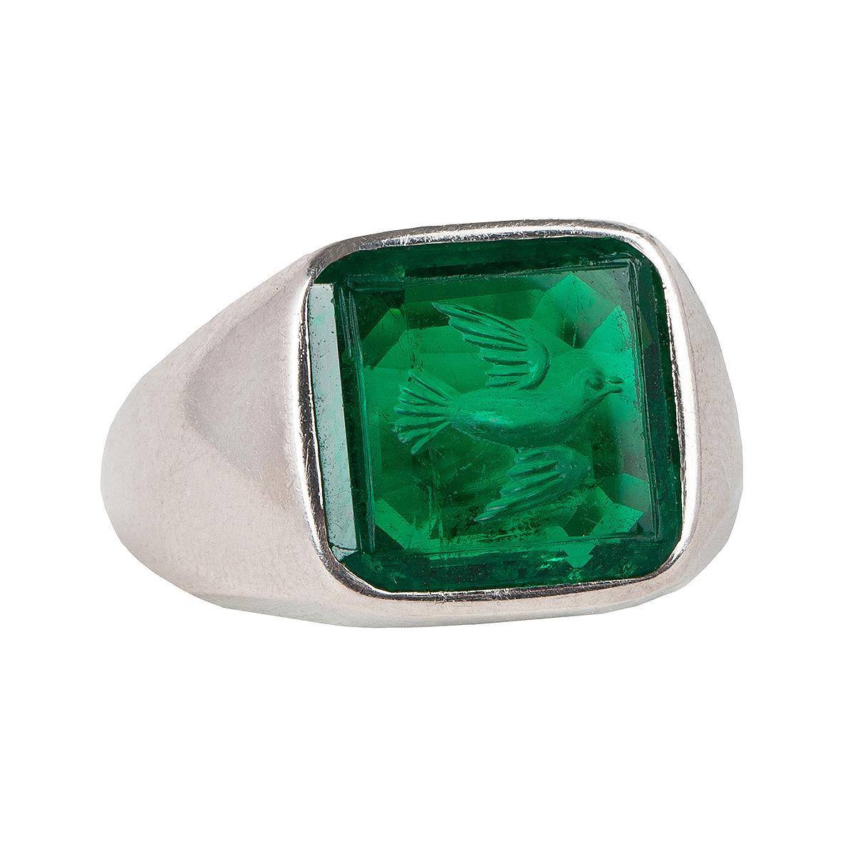  This ring a true piece of history made by a world-renowned jeweler. 
This emerald is 4.6 carats and is from Colombia. 
This is a vintage emerald from the 1920 era featuring an engraved bird motif.
We have 3 certificates for this ring. They are